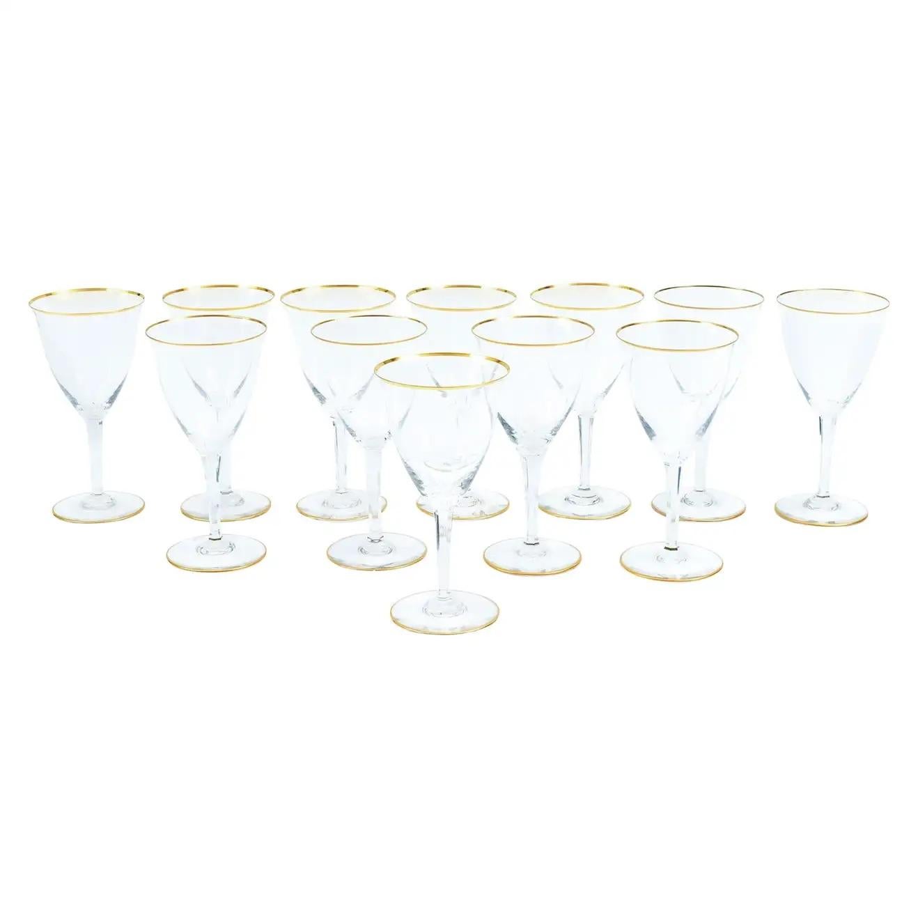 Large Baccarat crystal tableware / barware wine / water glassware service for twelve people with gilt gold trimmed top and base details. Each glass is in great vintage condition. Maker's mark etched underneath. Each glass measures 7. 3/4 inches tall
