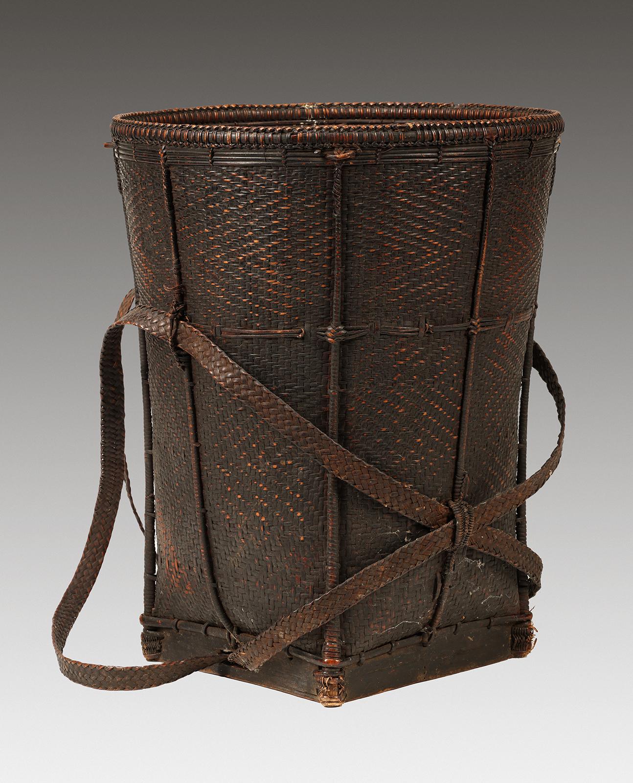 Tall Backpack Basket
Laos
Mid 20th century (or earlier)
Bamboo and rattan, twill weave
16.5″ high x 13″ diameter at top (42 x 33 cm)

From southern Laos, mostly rattan with some bamboo elements, used for foraging in the forest and carrying