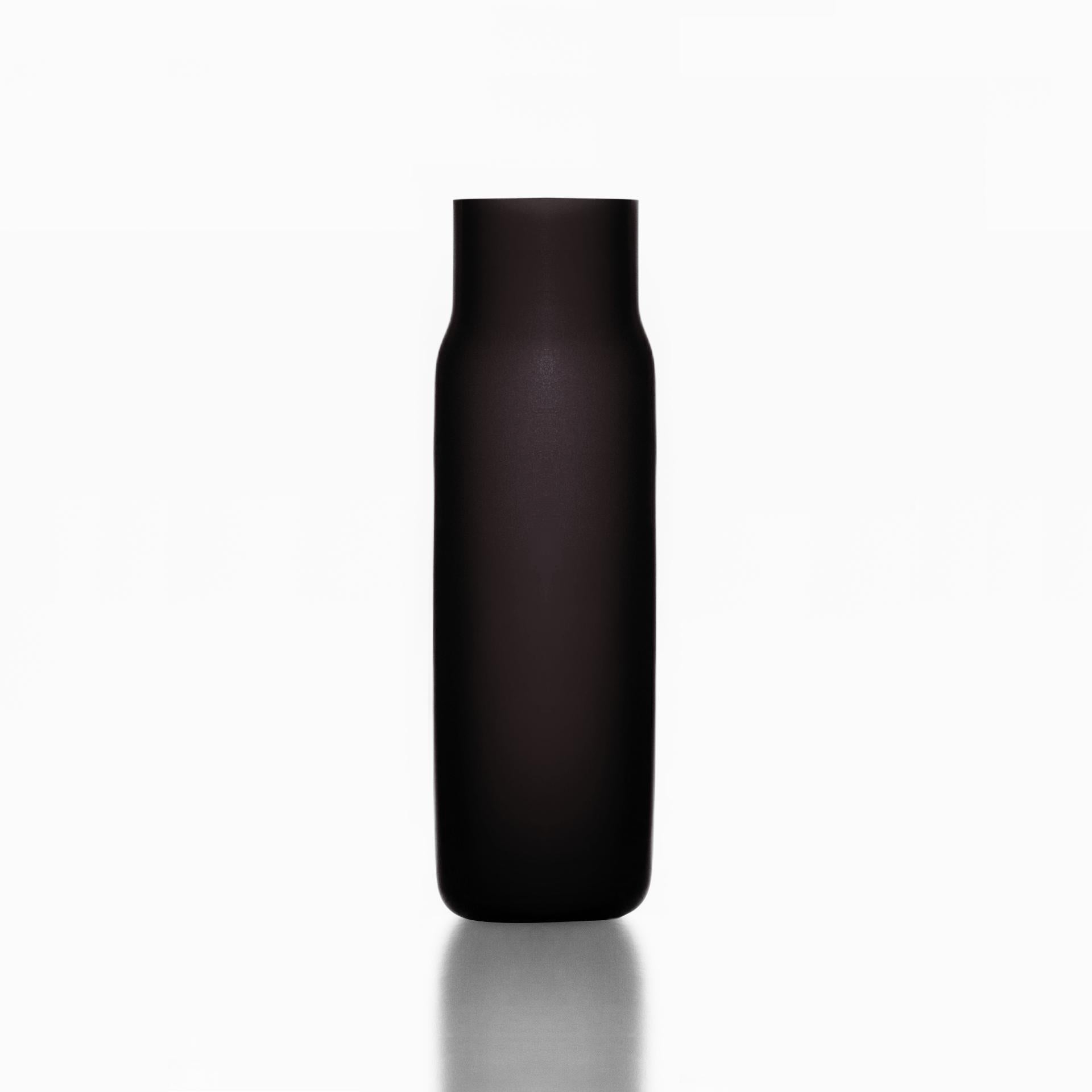 Tall black bandaska matte vase by Dechem Studio.
Dimensions: D 9 x H 31 cm.
Materials: glass.
Available in 4 sizes: D15 x H25/ D18 x H24/ D9 x W31/ D22 x H33 cm.
Available in black, uranium yellow, dark blue.

Hand-blown into beech wood mold,