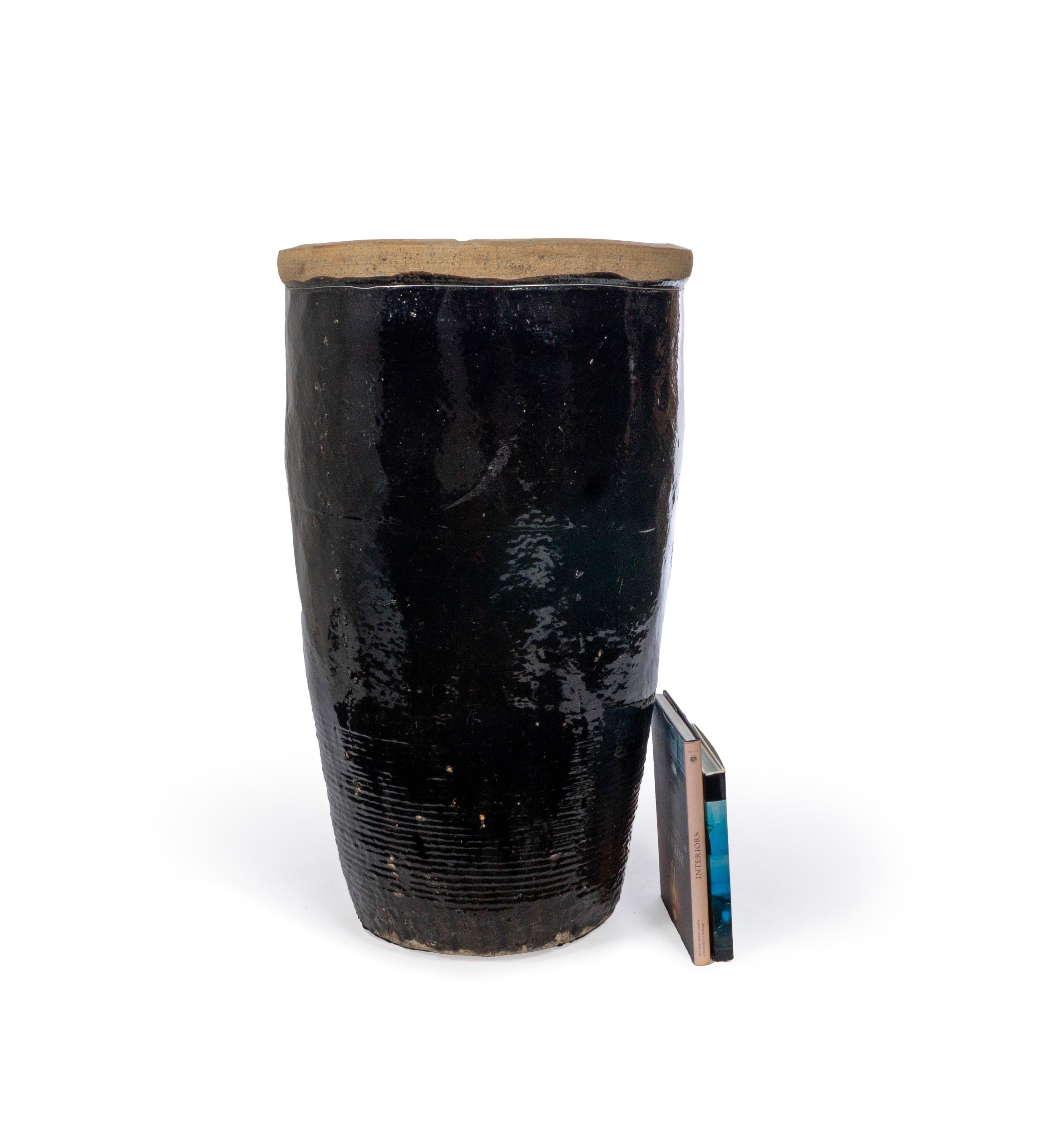 This storage jar features a beautiful sand-colored, textured lip and a glossy dark chocolate, black colored glaze throughout its length.

This piece is a part of one-of-a-kind collection, Le Monde. French for “The World”, the Le Monde collection