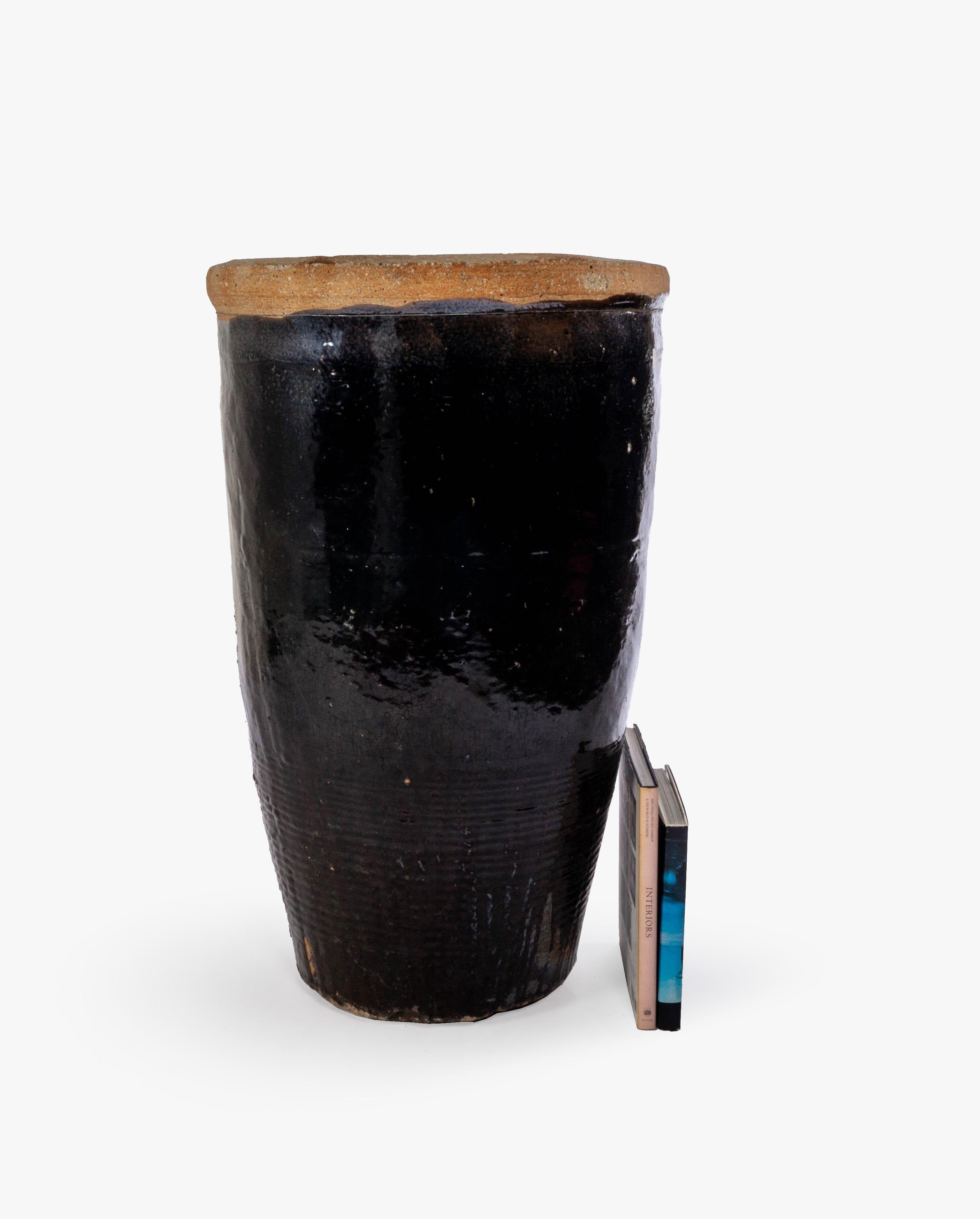 This storage jar features a beautiful sand-colored, textured lip and a glossy dark chocolate, black colored glaze throughout its length.

This piece is a part of one-of-a-kind collection, Le Monde. French for “The World”, the Le Monde collection