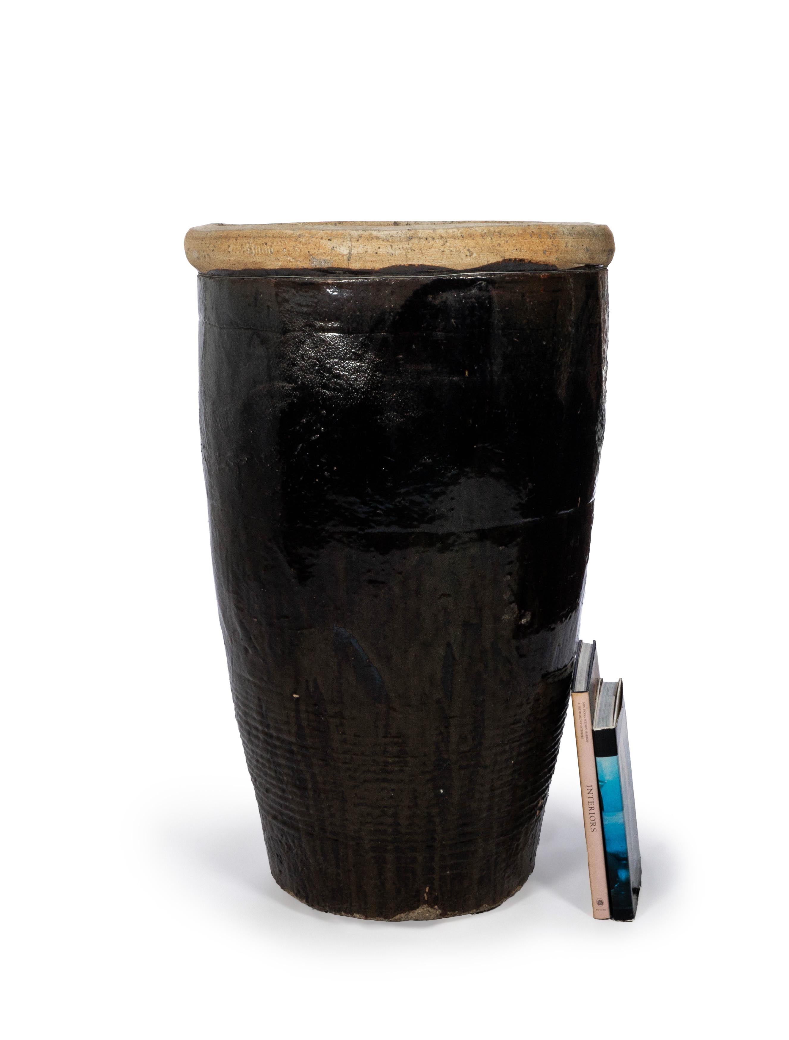 This storage jar features a beautiful sand-colored, textured lip and a glossy dark chocolate, black colored glaze throughout its length.

This piece is a part of Brendan Bass’s one-of-a-kind collection, Le Monde. French for “The World”, the Le