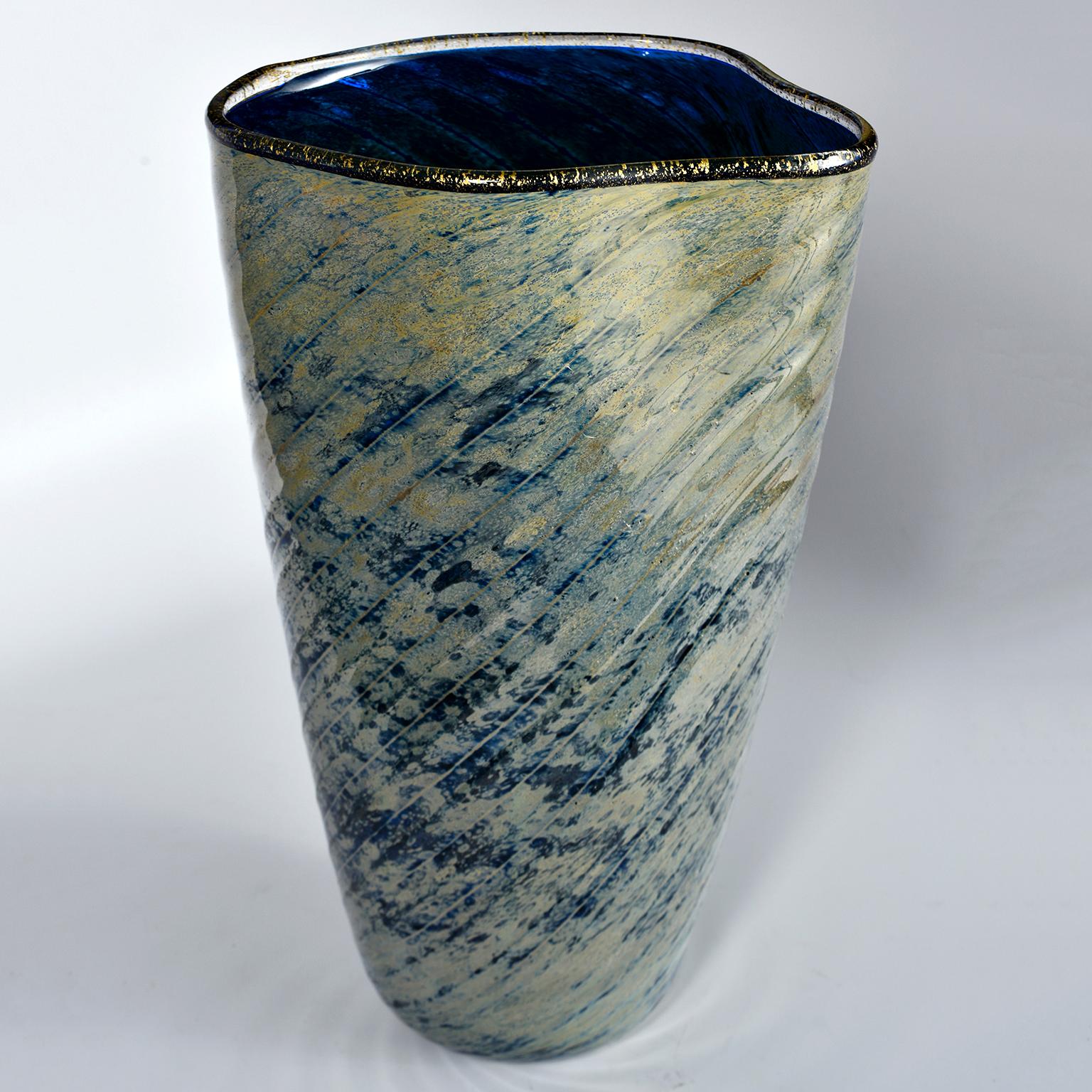 Tall art glass vase has a saturated cobalt interior with black, gold-infused lip and striated blue and gold outer surface. Dates from the 1990s. Unknown maker. Another piece by same artist in taller form with similar colors/style is available at the