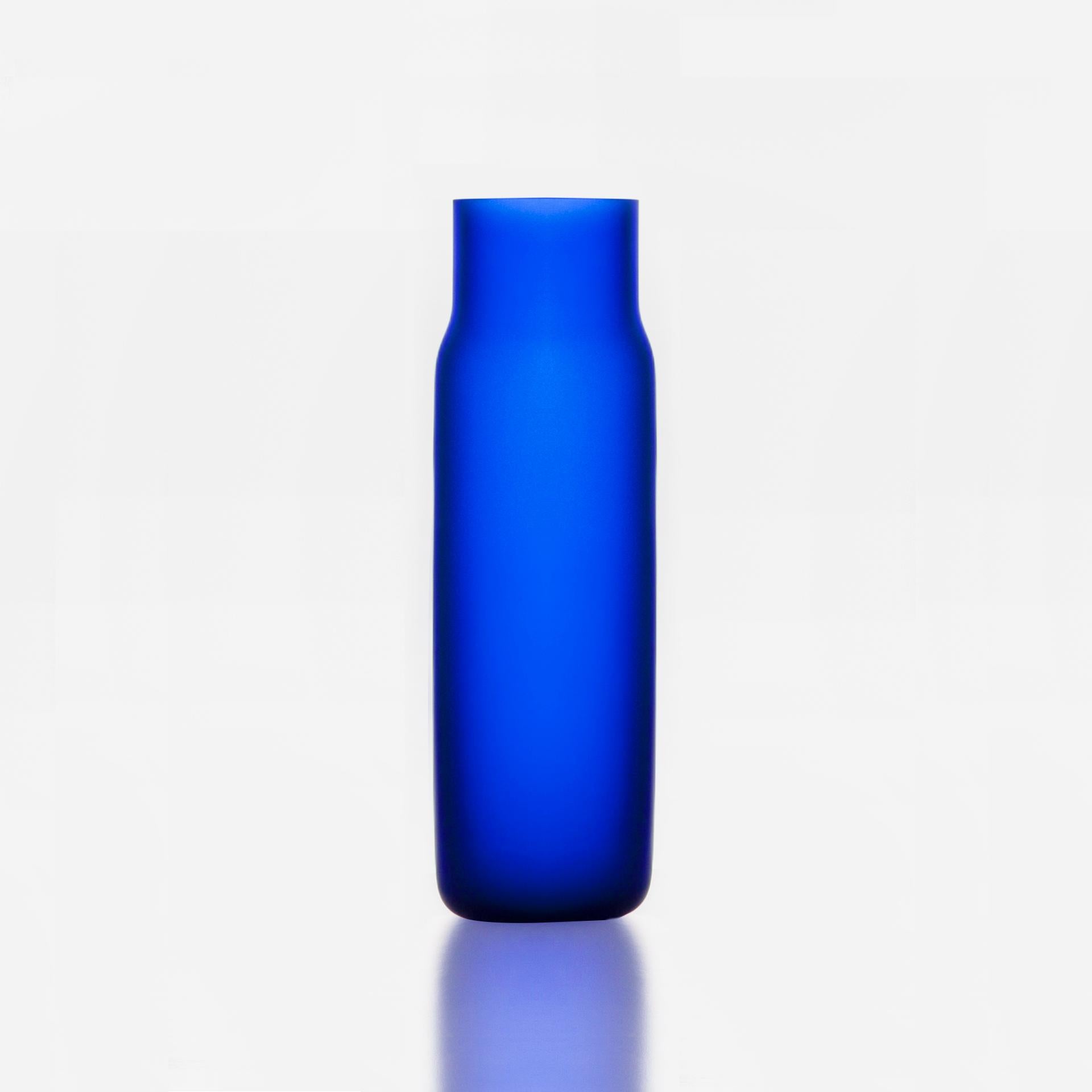 Tall Blue Bandaska Matte vase by Dechem Studio.
Dimensions: D 9 x H 31 cm.
Materials: glass.
Available in 4 sizes: D15 x H25/ D18 x H24/ D9 x W31/ D22 x H33 cm.
Available in black, uranium yellow, dark blue.

Hand-blown into beech wood mold,
