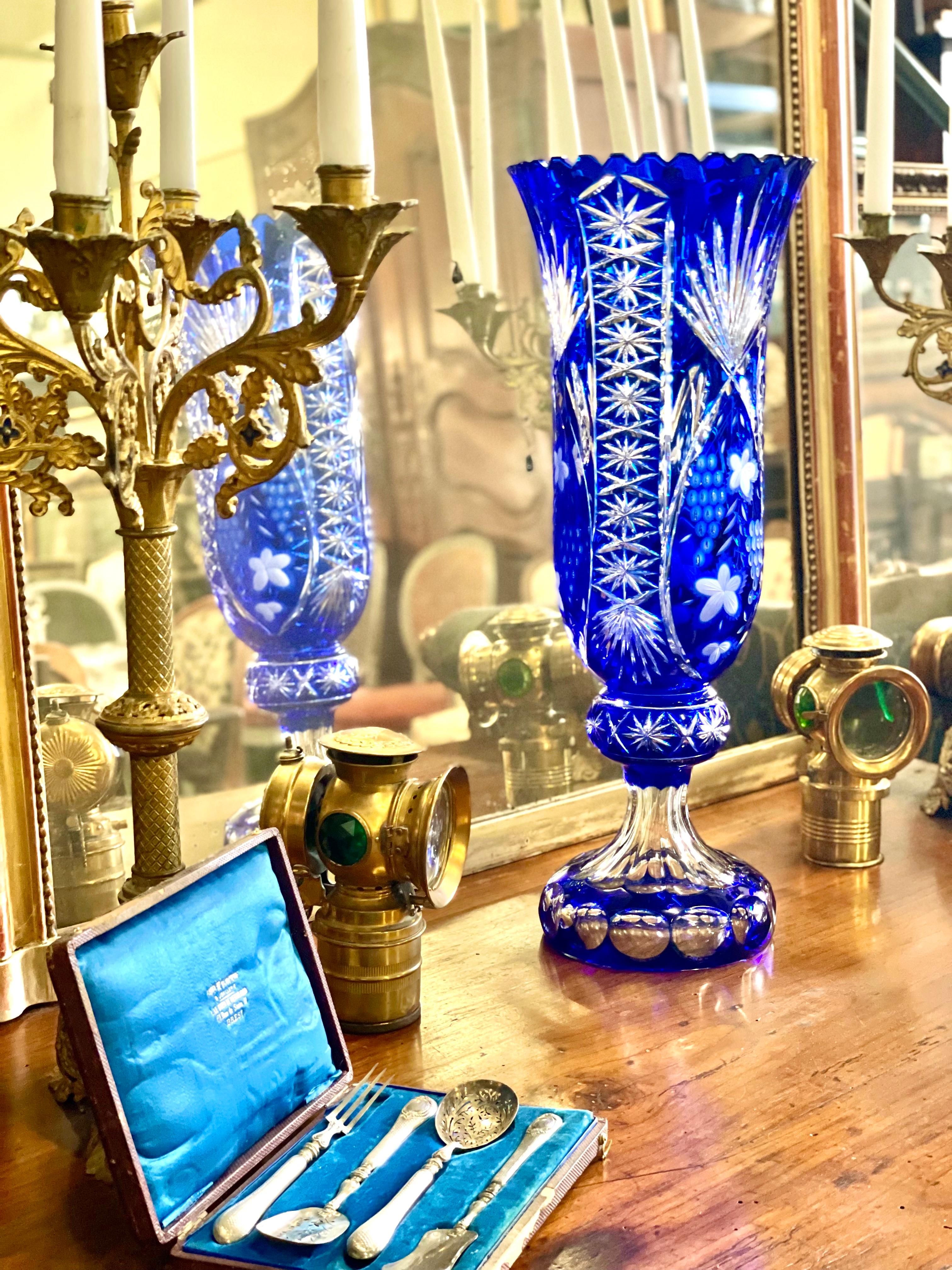 Diese spektakuläre hohe Vase, die über 53 cm misst, ist ein Meisterwerk aus blauem geschliffenen Kristall. Die lebendige Kobaltschicht wird fachmännisch geschliffen, um schillernde florale Motive, Sternsprünge und komplizierte geometrische Muster in
