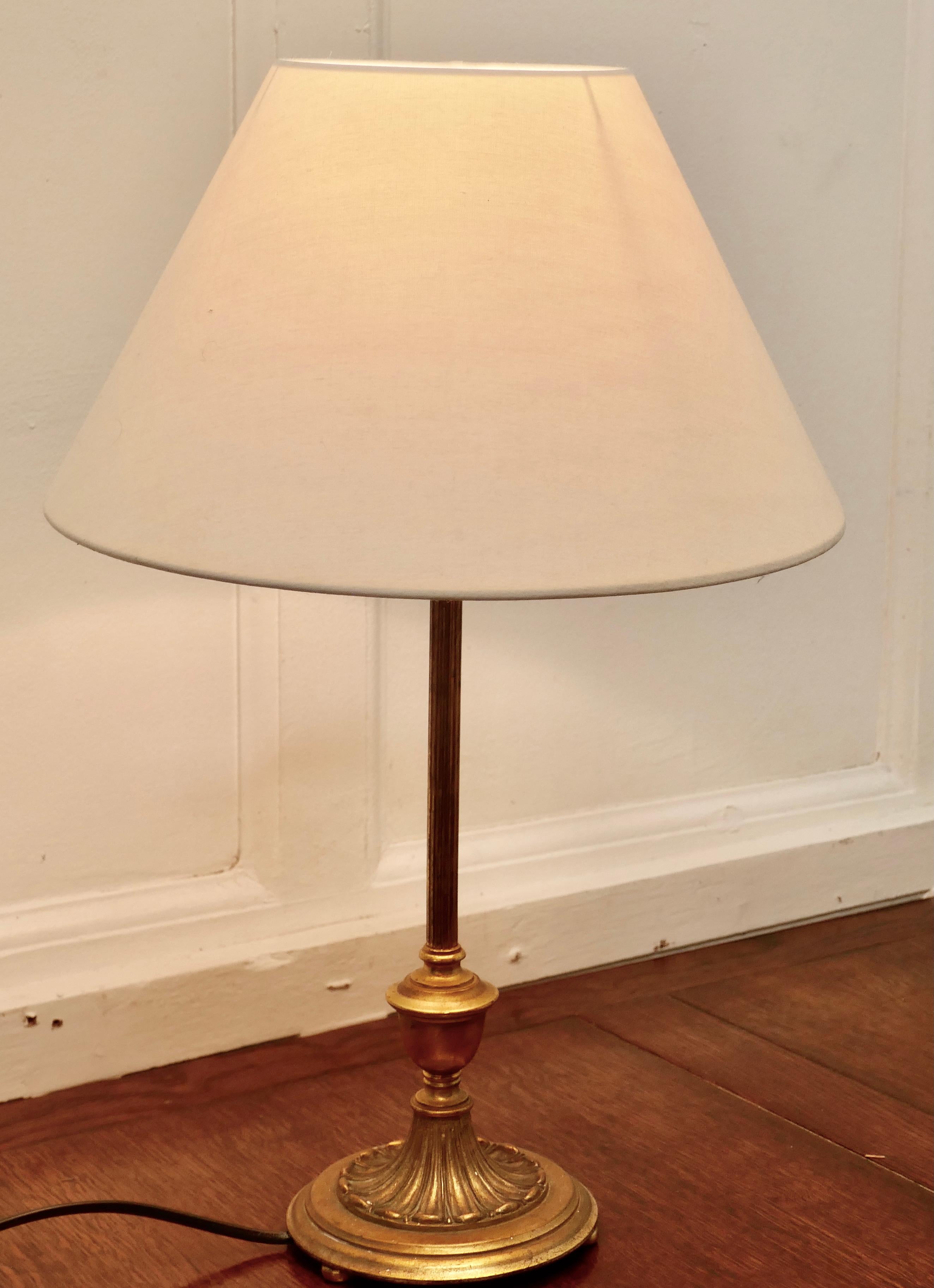 Tall brass Arts & Crafts table lamp 

A decorative table lamp, the base is circular decorated in the classical style with a slender column
The lamp has a pretty cone shaped shade, it is in good working order, it is 19” tall, and the shade is 12”
