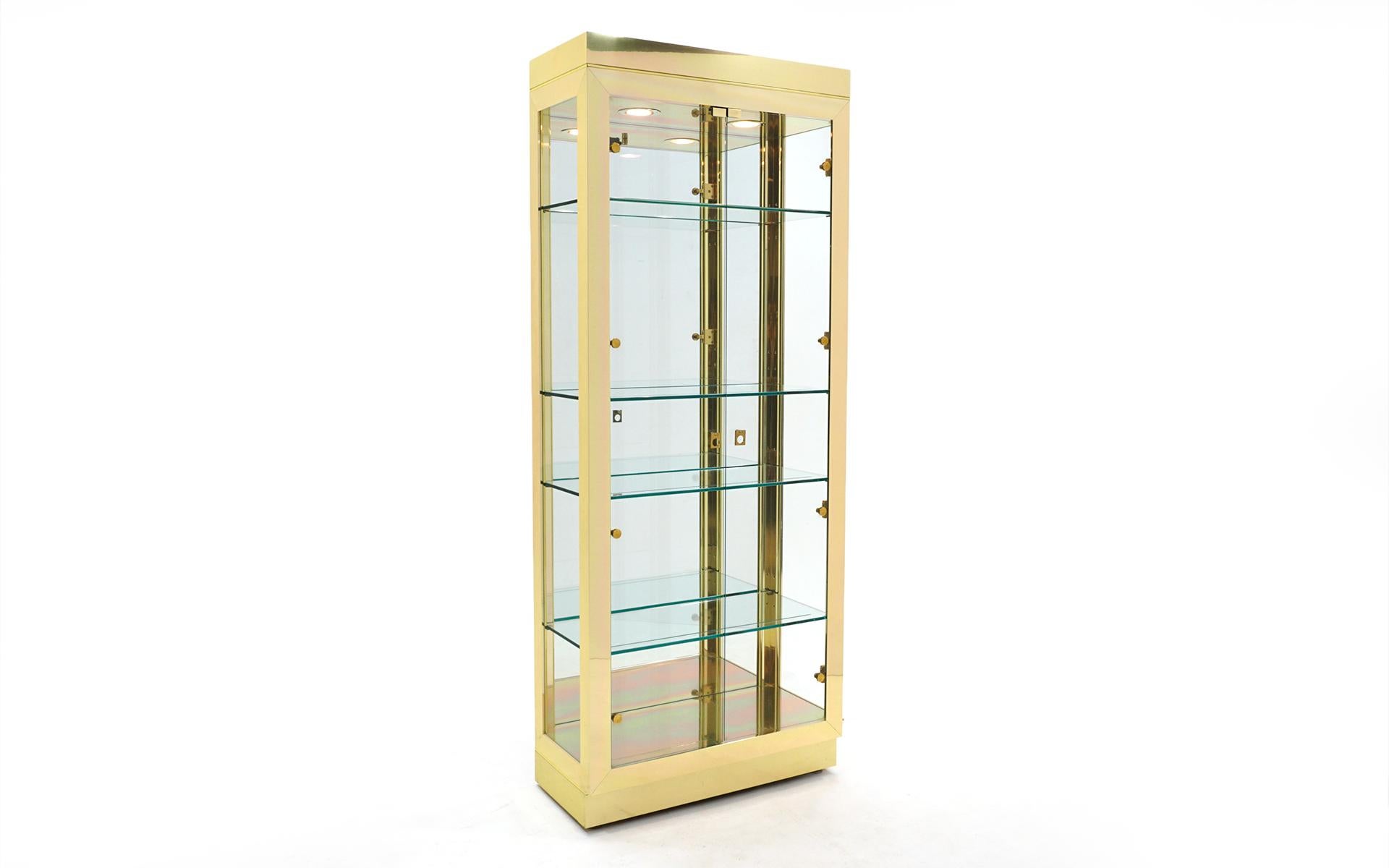 Vertical Display / Storage cabinet in brass with four adjustable glass shelves and mirrored inside back (this making it difficult to photograph!).  It is even better in person.  Super high quality construction possibly by Pace or Ello.  Completely