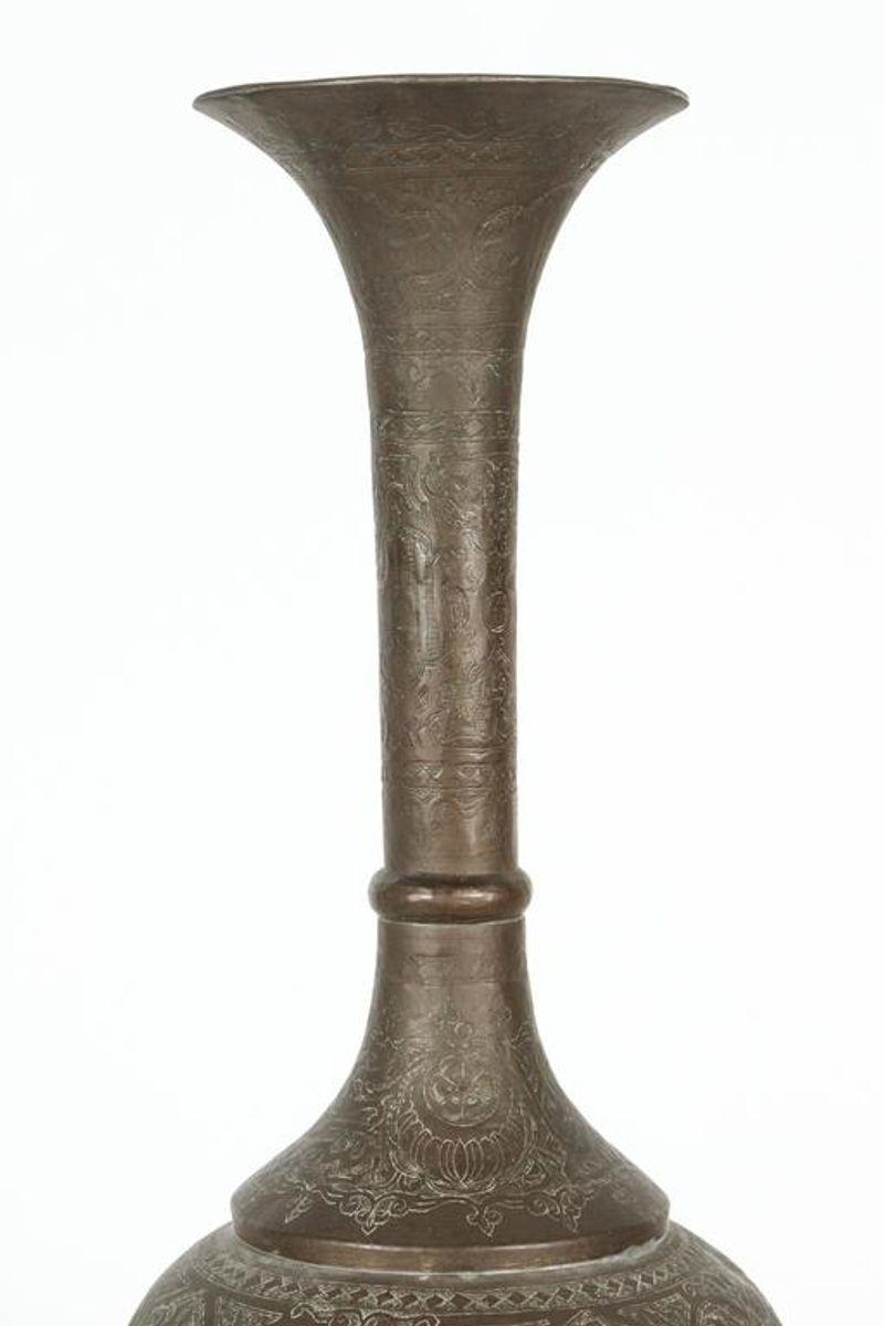 Tall brass Middle Eastern Persian vase in a trumpet shape.
Handcrafted large sculptural elegant bronzed color metal Moorish vase.
Delicately handmade and etched with very fine floral and geometrical Islamic designs with Arabic calligraphy