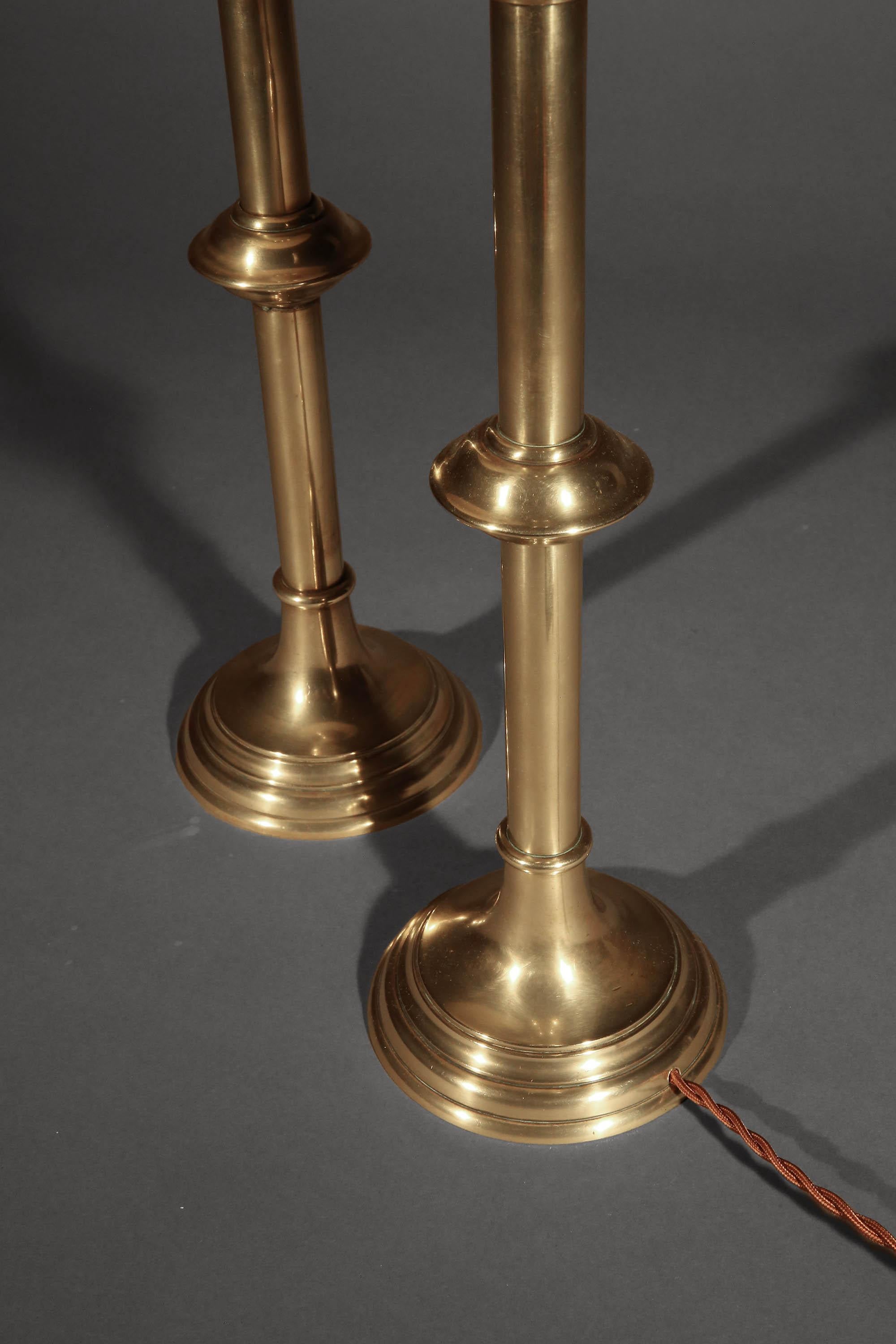 A pair of rare and elegant and tall antique brass table lamps from the 19th century, originating in England.

Why We Like Them:

These stunning lamps offer a unique blend of simplicity and sophistication. The sleek, elongated stems, which feature a