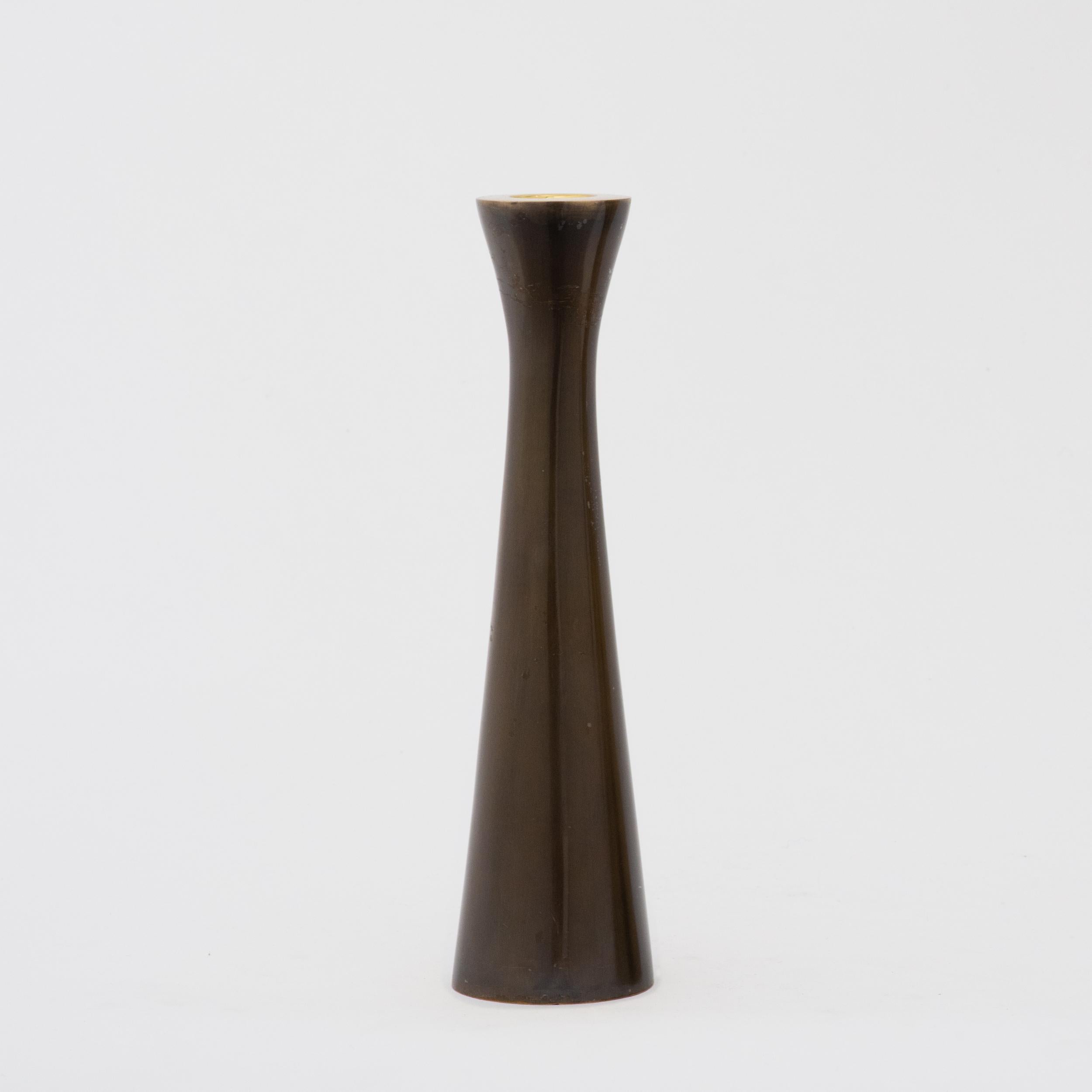 Tall tapered candleholder cast in brass with a bronze patina finish. Also available in brass with a brushed finish.

Measures: Height 21.7 cm / 8.5 in
Diameter 5.3 cm / 2 in.