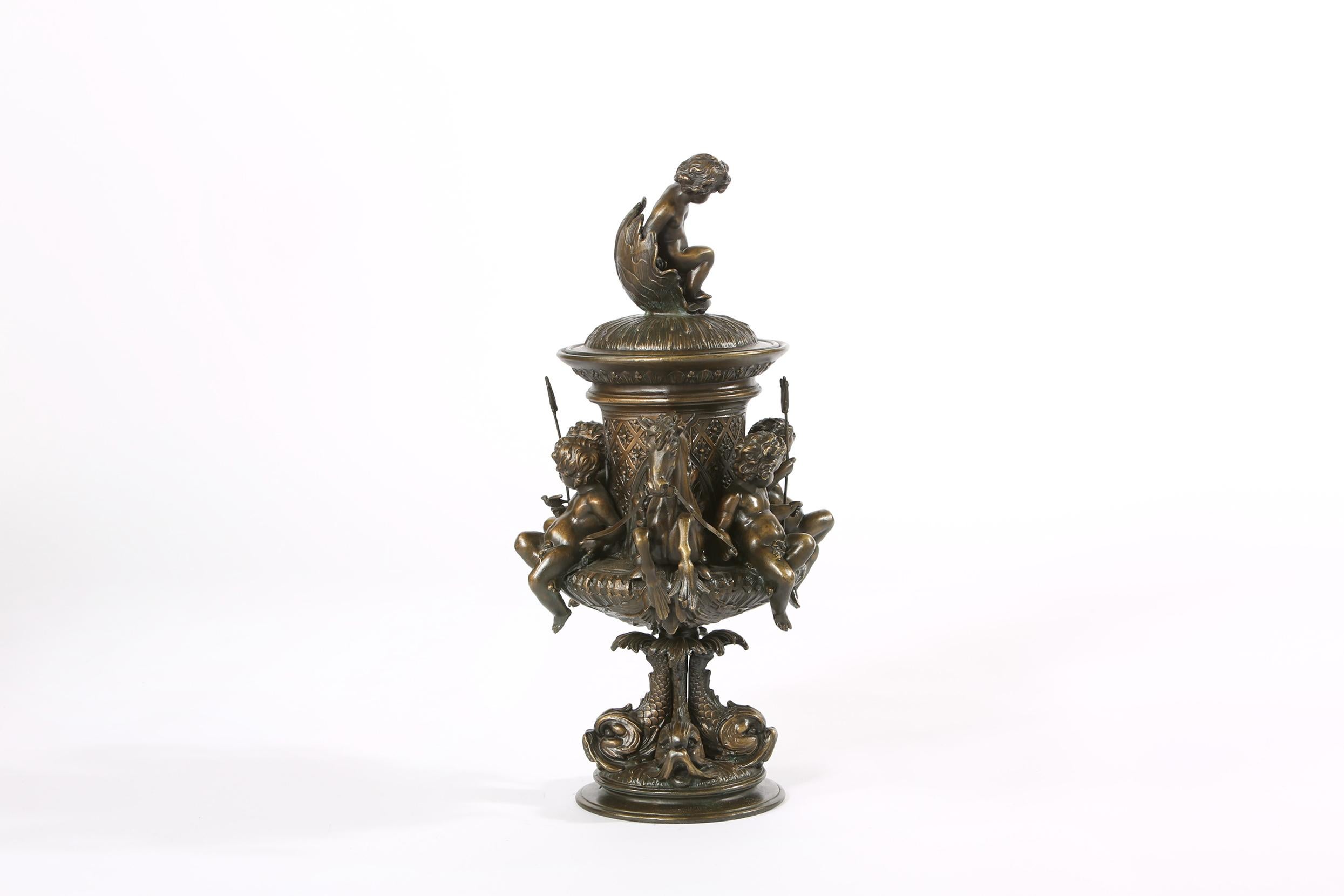 Early 20th century tall bronze non removable covered urn / centerpiece. The centerpiece is in great condition. It measures about 21 inches high x 14 inches wide.