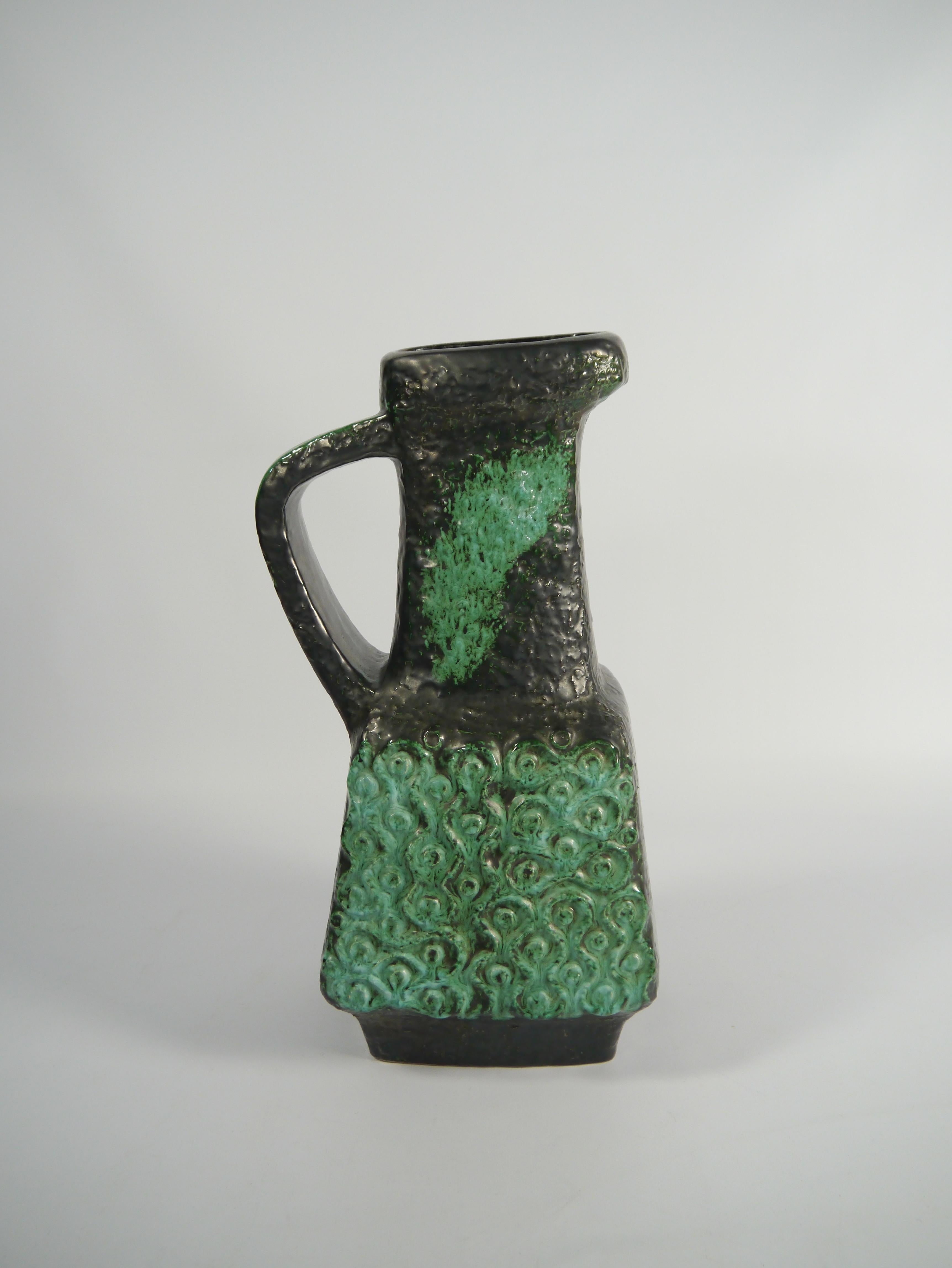 Tall brutalist style ceramic vase produced by BAY in the 1970s. Clean and straight symmetrical shape with graffiti-like green pattern, indeed conversation piece material.