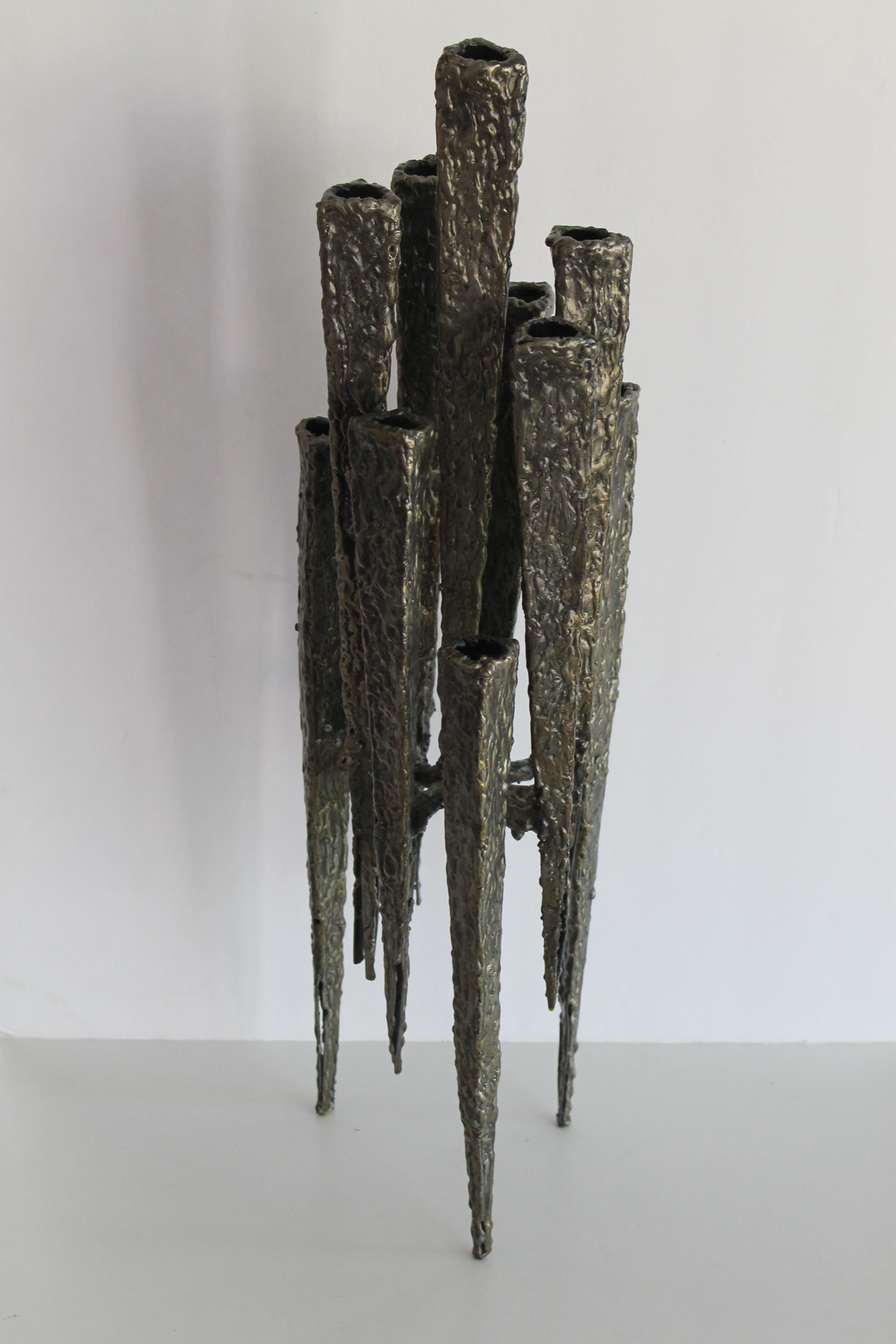 A welded steel mid century candlestick sculpture, ten vertical elements at different levels. 1970's modern form, reminiscent of Paul Evans' work. Measures: 6