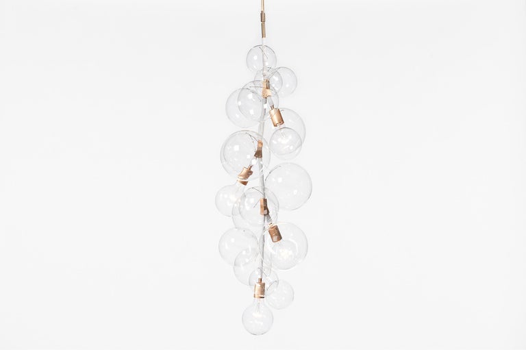 Tall bubble chandelier by Pelle
Dimensions: D 38 x H 119 cm
Materials: Machined brass and aluminum, hand-blown glass globes, decorative cotton or leather coiling.
Weight: 8.2 kg
Metal finish options: Standard: Satin brass, polished