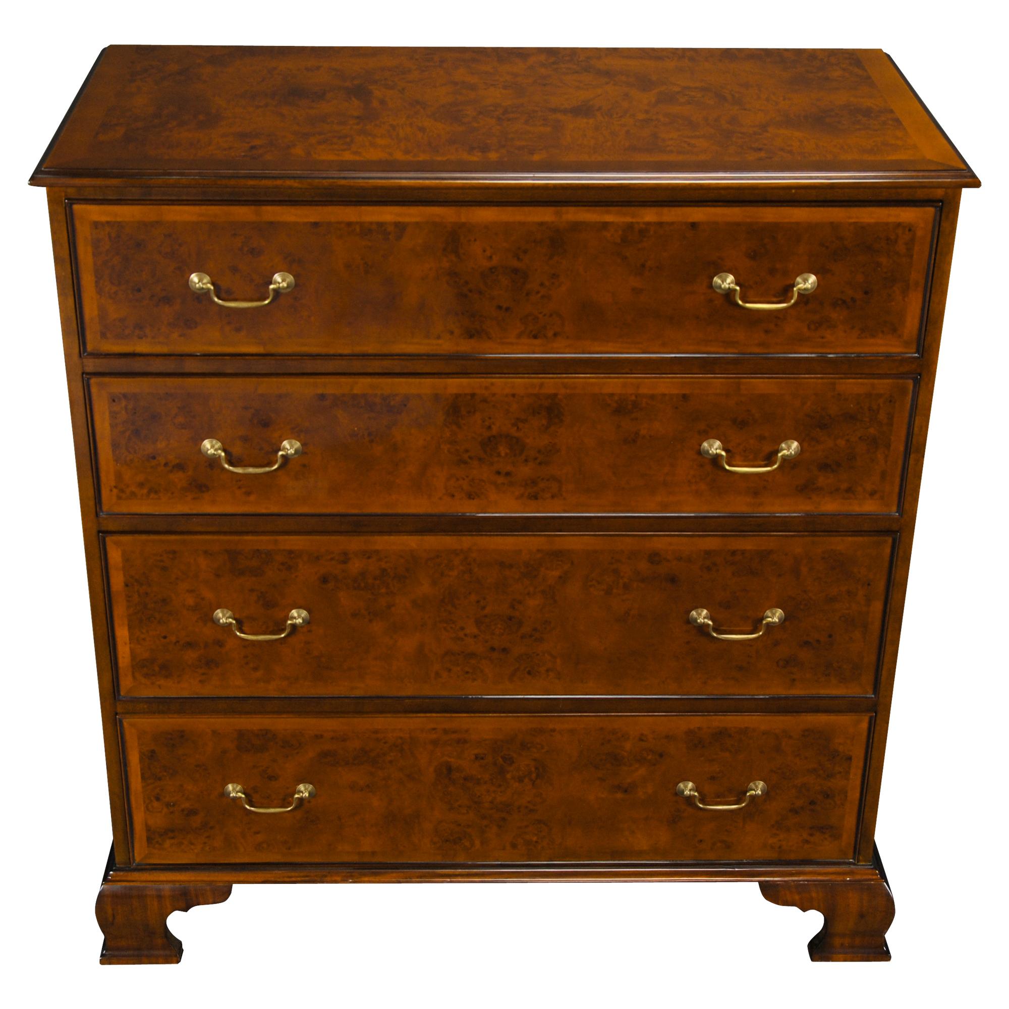 This version of a Tall Burled Dresser, a design inspired form an eighteenth century English chest of drawers. Decorative and functional best describe this high quality tall chest which is a reproduction of an English antique original. Produced using