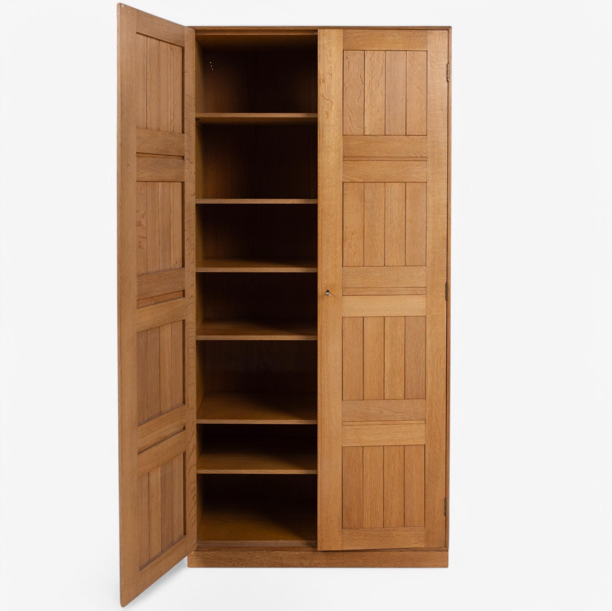 Tall cabinet in solid patinated oak with matching base.