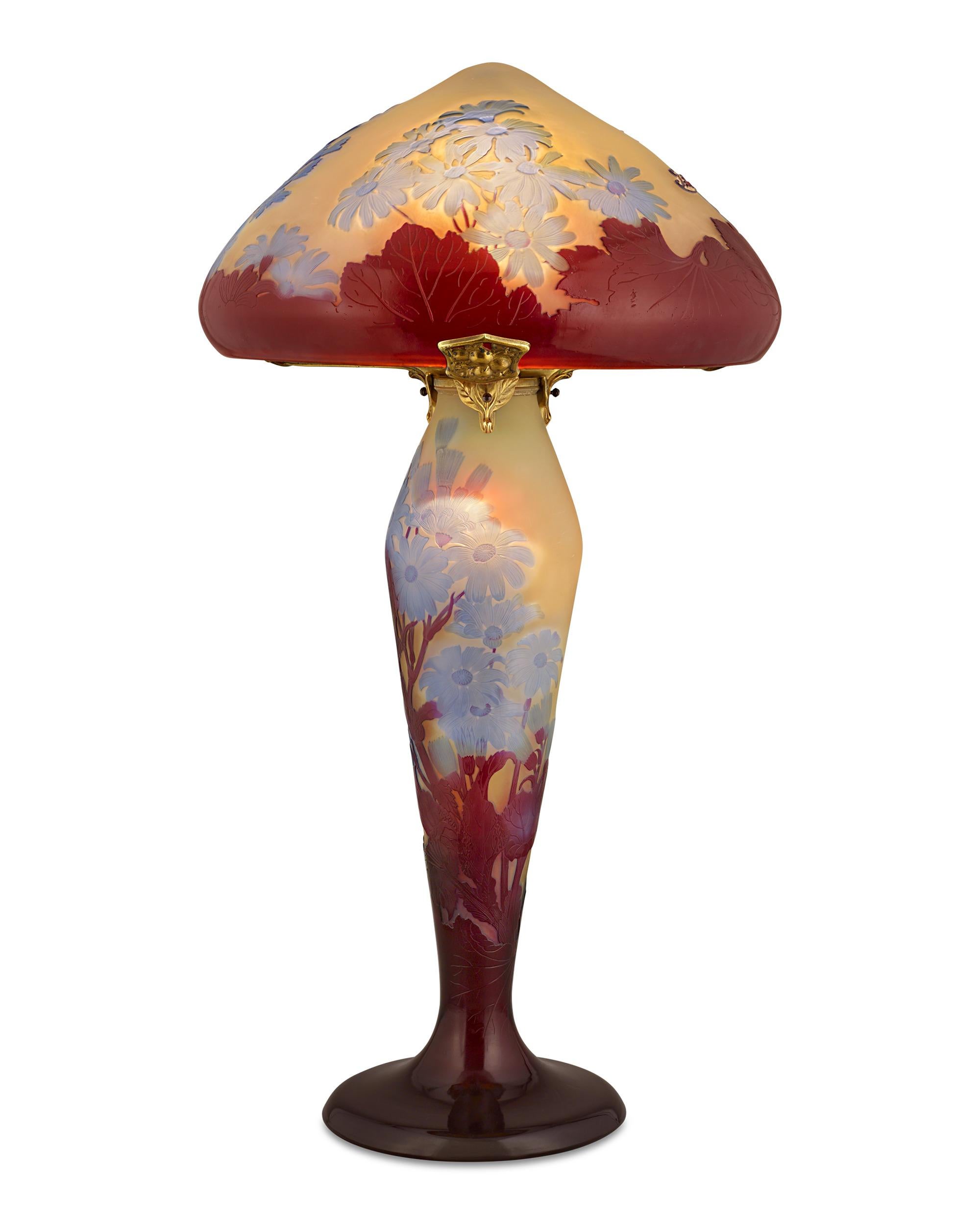 Impressive in both size and artistry, this exceptional cameo glass lamp is the work of the famed Art Nouveau master Émile Gallé, one of the most highly regarded names in French glassmaking. The artist's appreciation of nature is evident in the