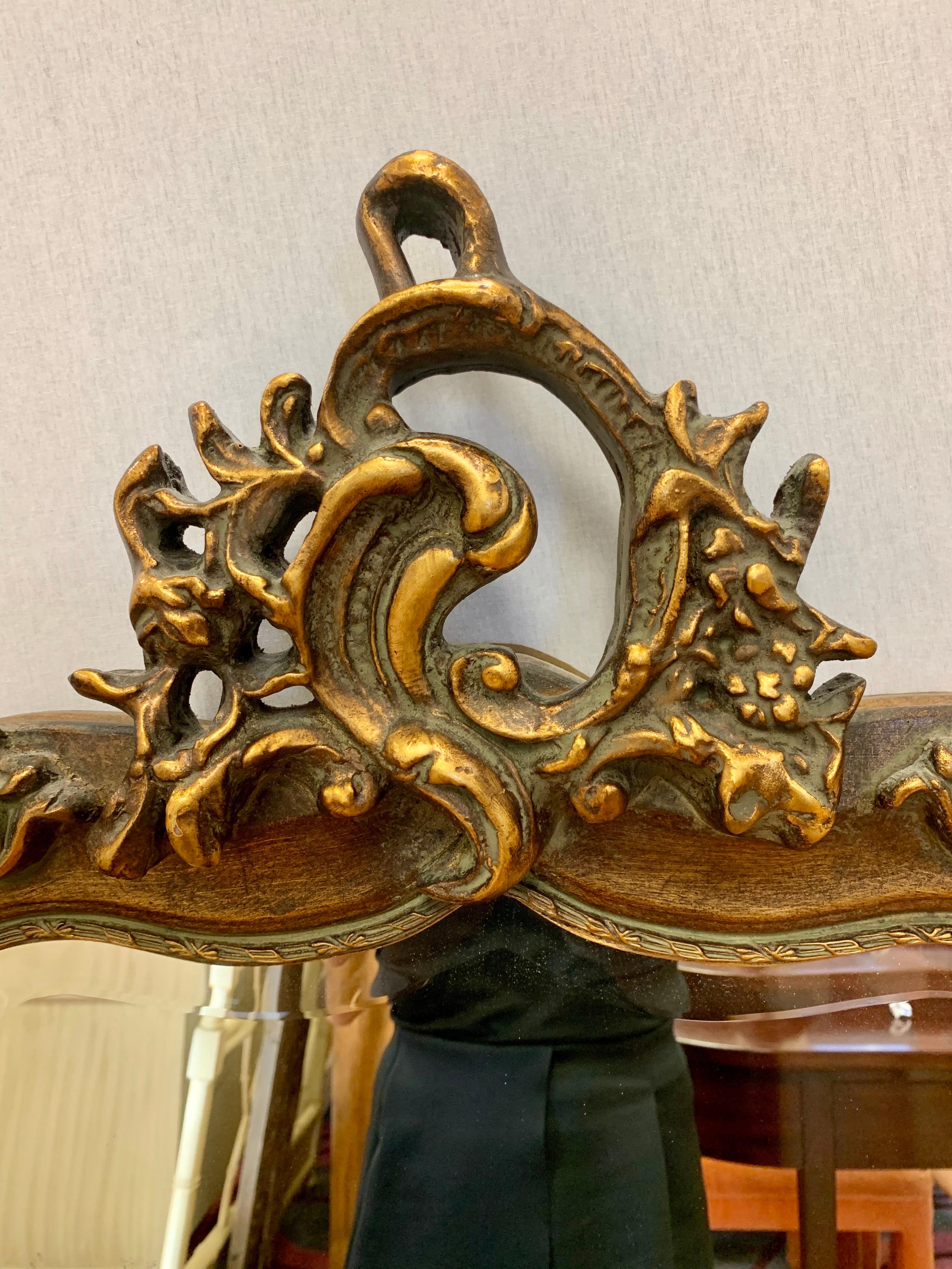 A beautiful antique tall giltwood floor mirror with intricately carved detail at the top and corners. Has beveled glass and is ready to hang. Great lines and better scale - not too big but not too small.