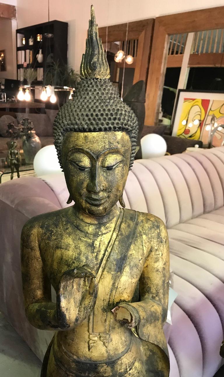 Tall hand carved wooden standing Buddha on display stand. Likely Thai. Beautifully carved and detailed. 

Great addition to any collection or eye-catching accent piece to any setting. 

Dimensions: 54