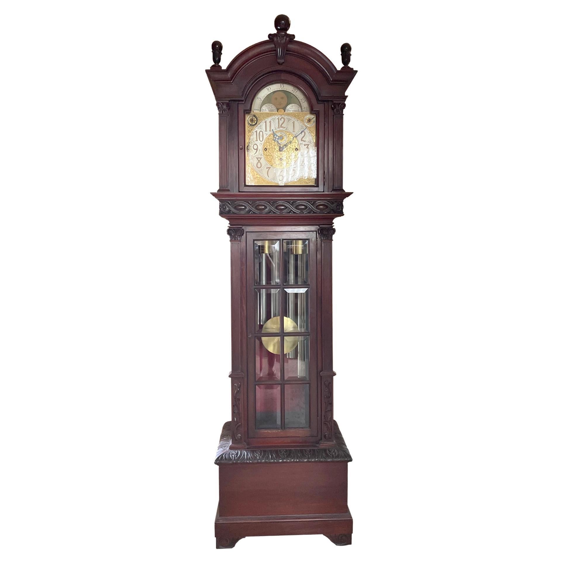 A circa 1916, Colonial Manufacturing Co., 9-tube Grandfather clock with highly decorative hand-carved Honduras Mahogany tall case and Herschede movement. Colonial was located in Zeeland, MI and produced clocks from 1906 until 1983 when the company