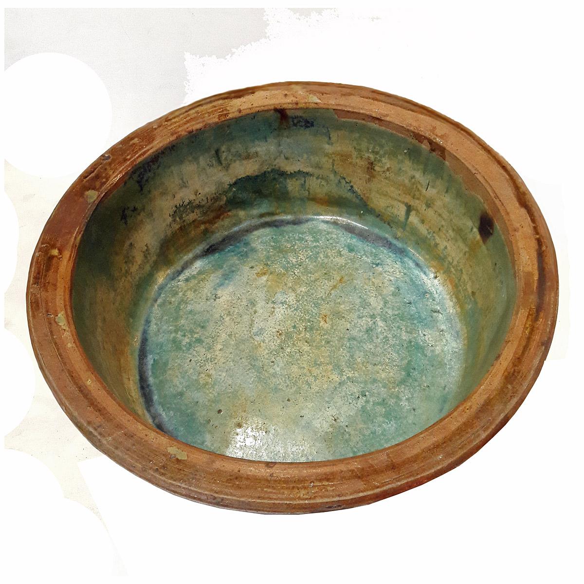 A tall and large ceramic bowl from Indonesia with brown ridged exterior and a green glazed interior, circa 1960.