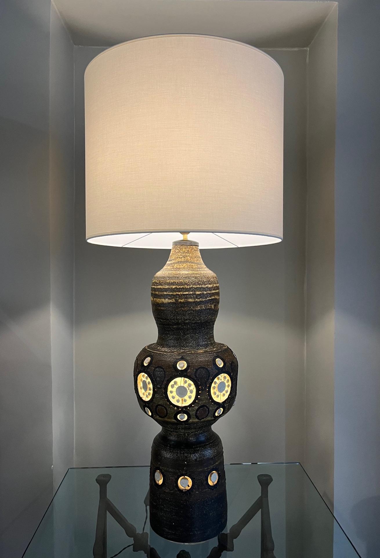  Tall ceramic lamp by Georges Pelletier.
Glazed ceramic with white glazed openwork around the body of the lamp. 
Electrified inside the lamp body.
South of France  ( Cannes) circa 1970 

There is a hole at the base of the collar. It is original and