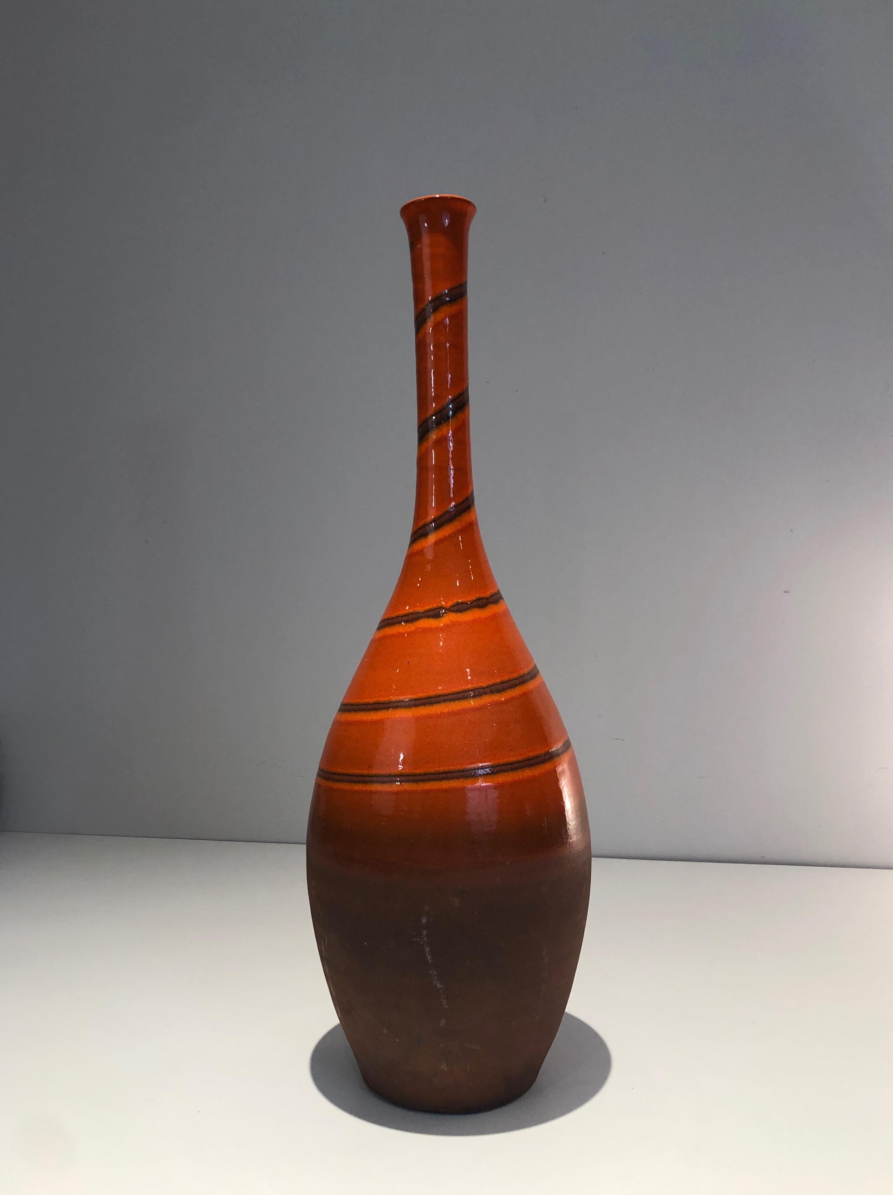 Tall ceramic vase in the red-orange tones. French work. Circa 1950.