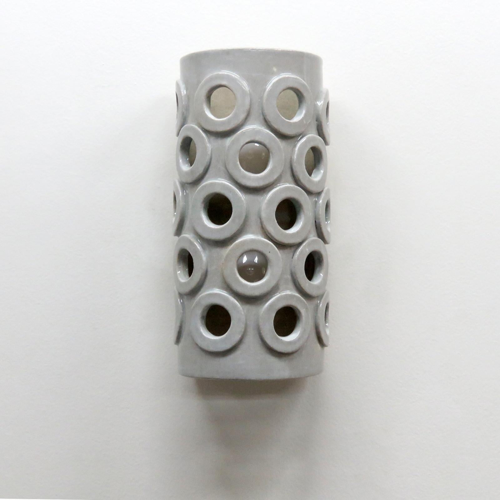 Stunning tall semi-cylindrical ceramic wall light No.51, designed and handcrafted by Los Angeles based ceramicist Heather Levine. High fired stoneware with grey/white glaze body with decorative perforations to expose light in patterns on nearby
