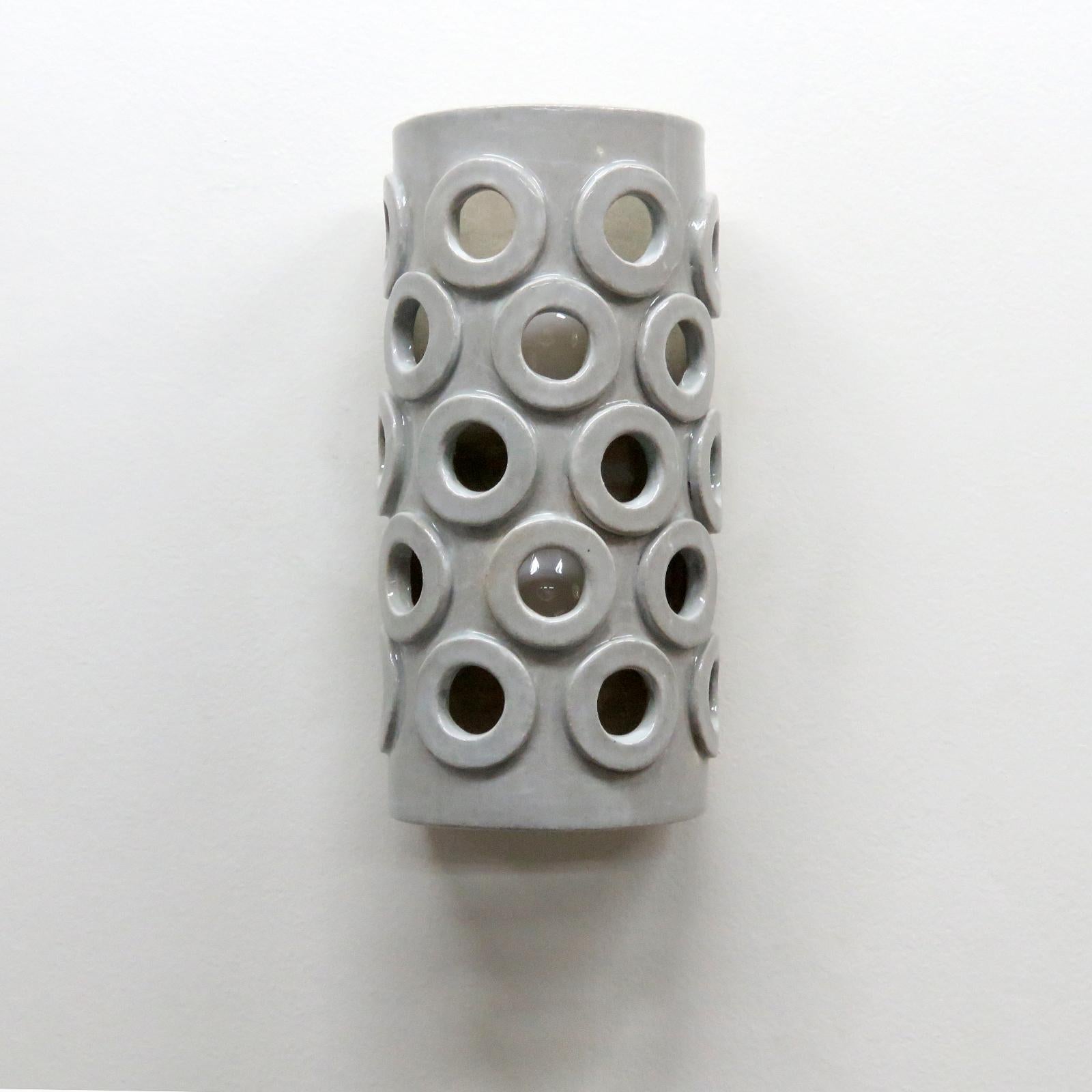 Stunning tall semi-cylindrical ceramic wall light No.51, designed and handcrafted by Los Angeles based ceramicist Heather Levine. High fired stoneware with grey/white glaze body with decorative perforations to expose light in patterns on nearby