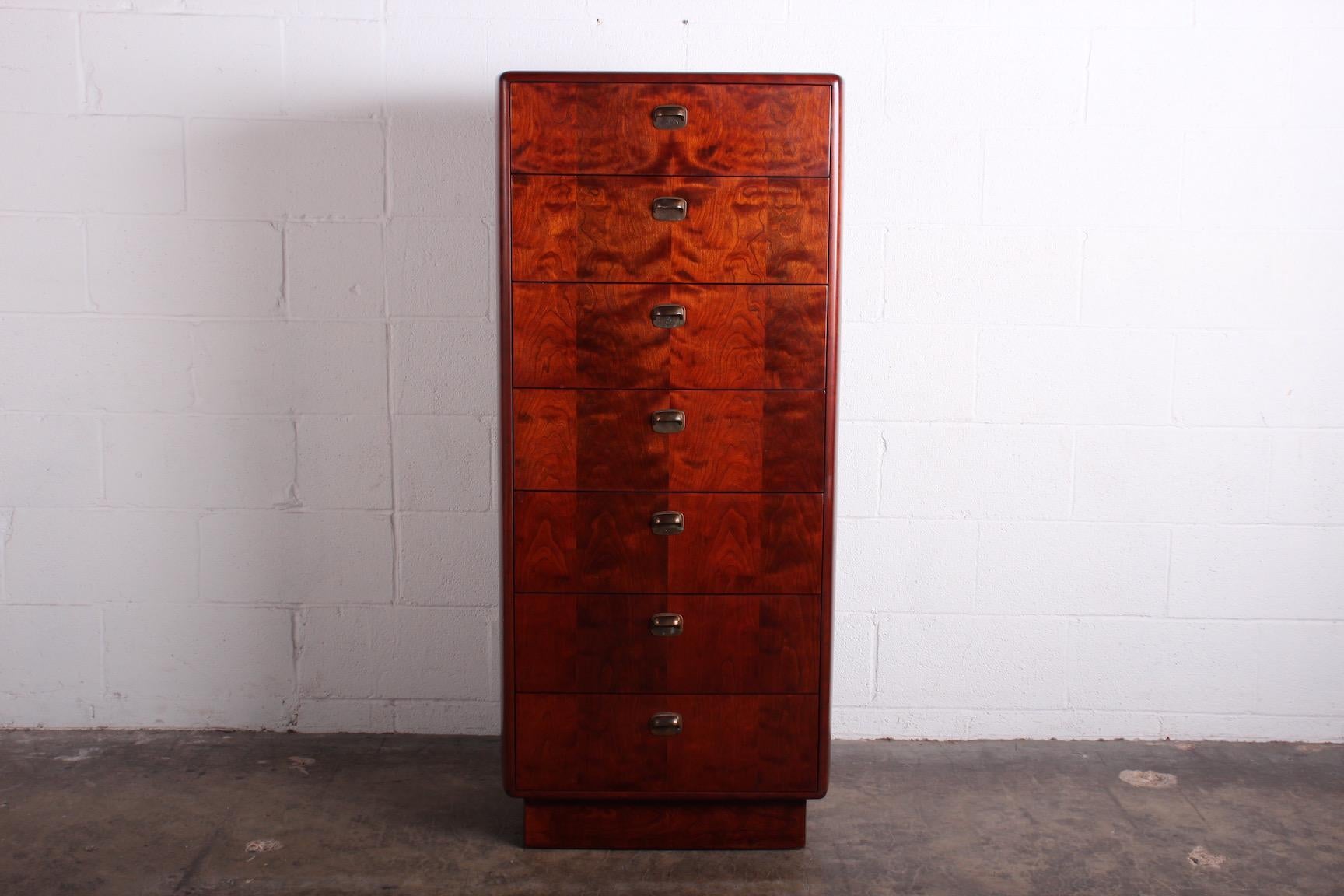 A tall chest of drawers with bronze hardware. Designed by Edward Wormley for Dunbar.