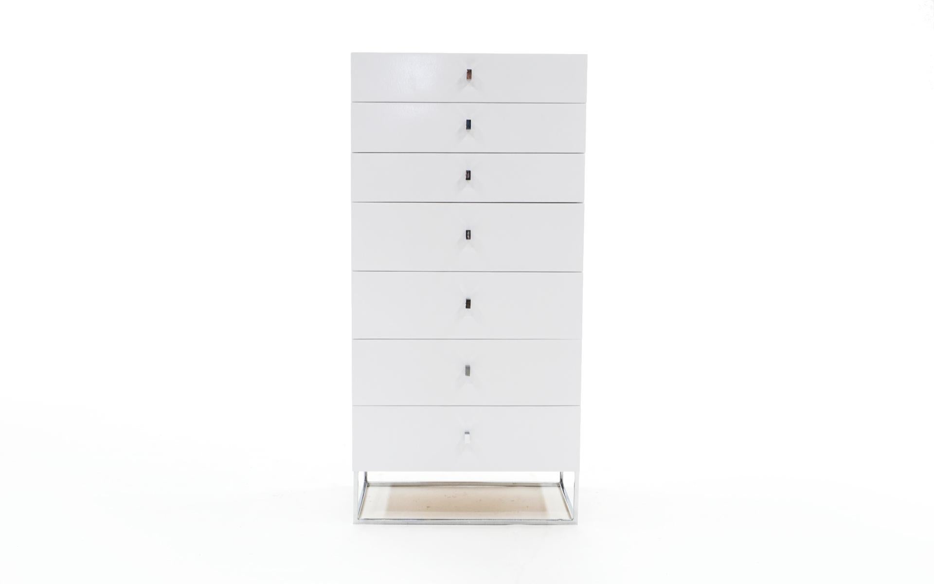 Roger Rougier white lacquered chest of seven drawers / dresser with chromed steel base and pulls. This piece has been repainted with only a few blemishes which are evident in the photos.