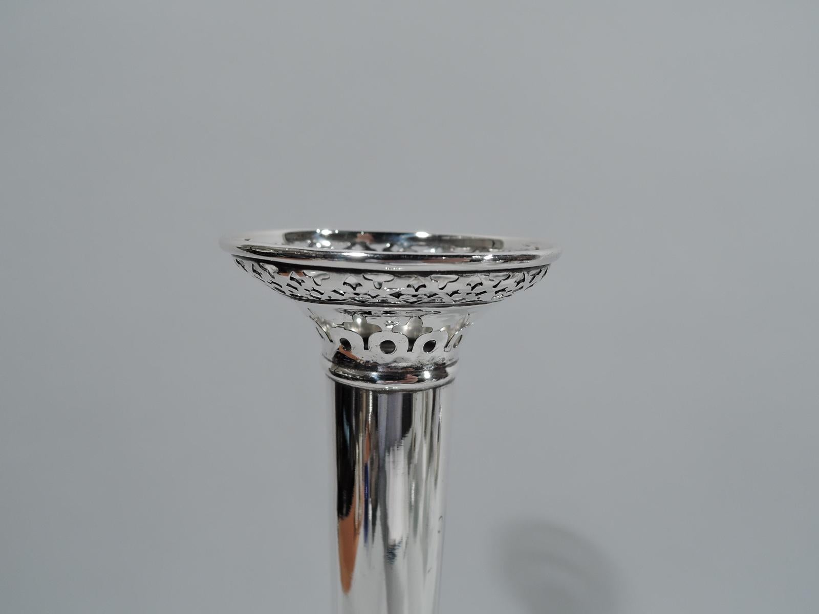 Tall and chic sterling silver bud vase. Made by La Pierre (part of International) in Newark, ca 1910. Narrow and elongated cone on raised foot; mouth curved with ornamental piercing. Fully marked including maker’s stamp and no. 825. Weighted.