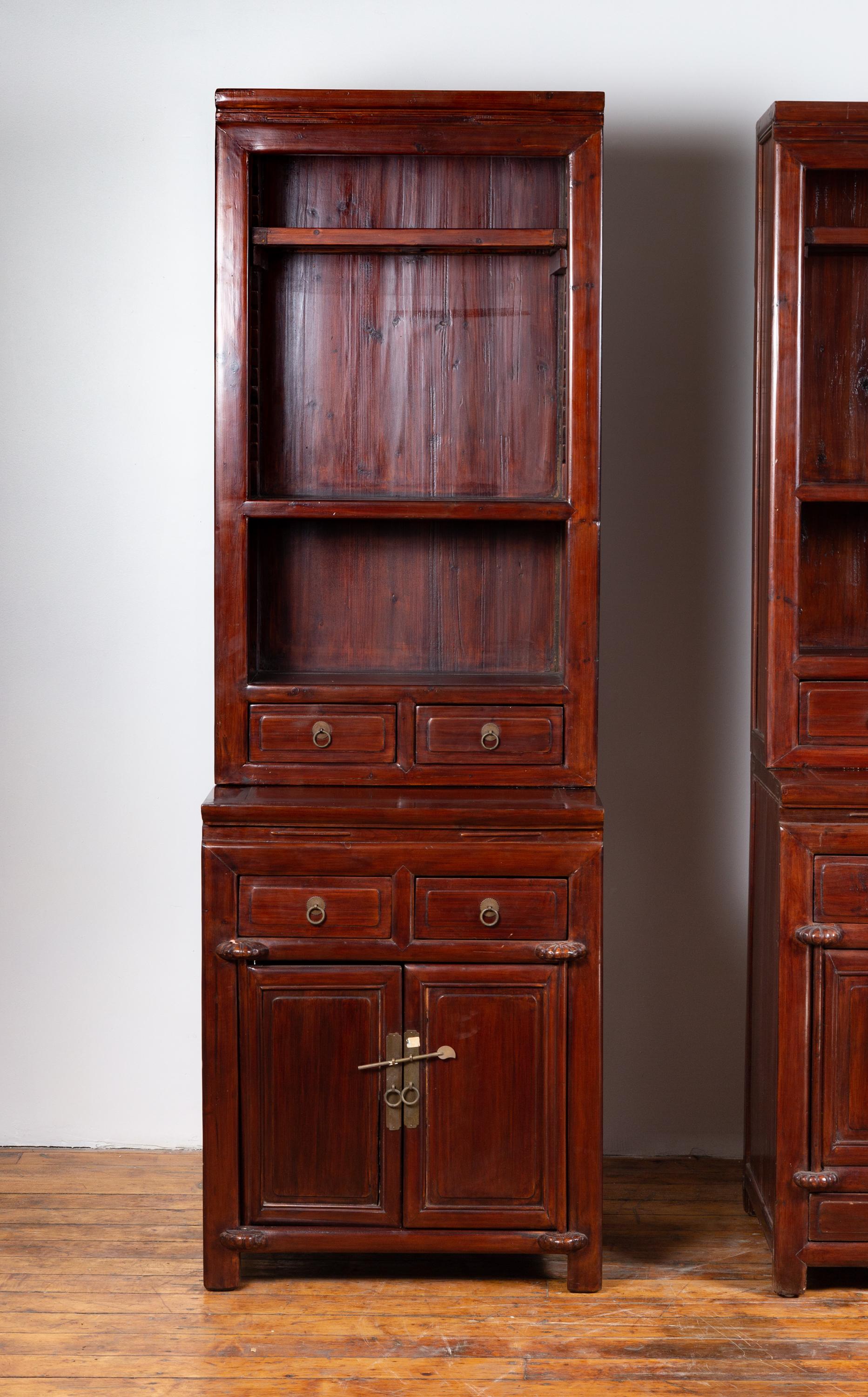 A tall Chinese antique two-part wooden lacquered cupboard from the early 20th century, with open shelves, doors and drawers, perfect to work as a pair with its twin (see item LU863916021422). Born in China during the early years of the 20th century,