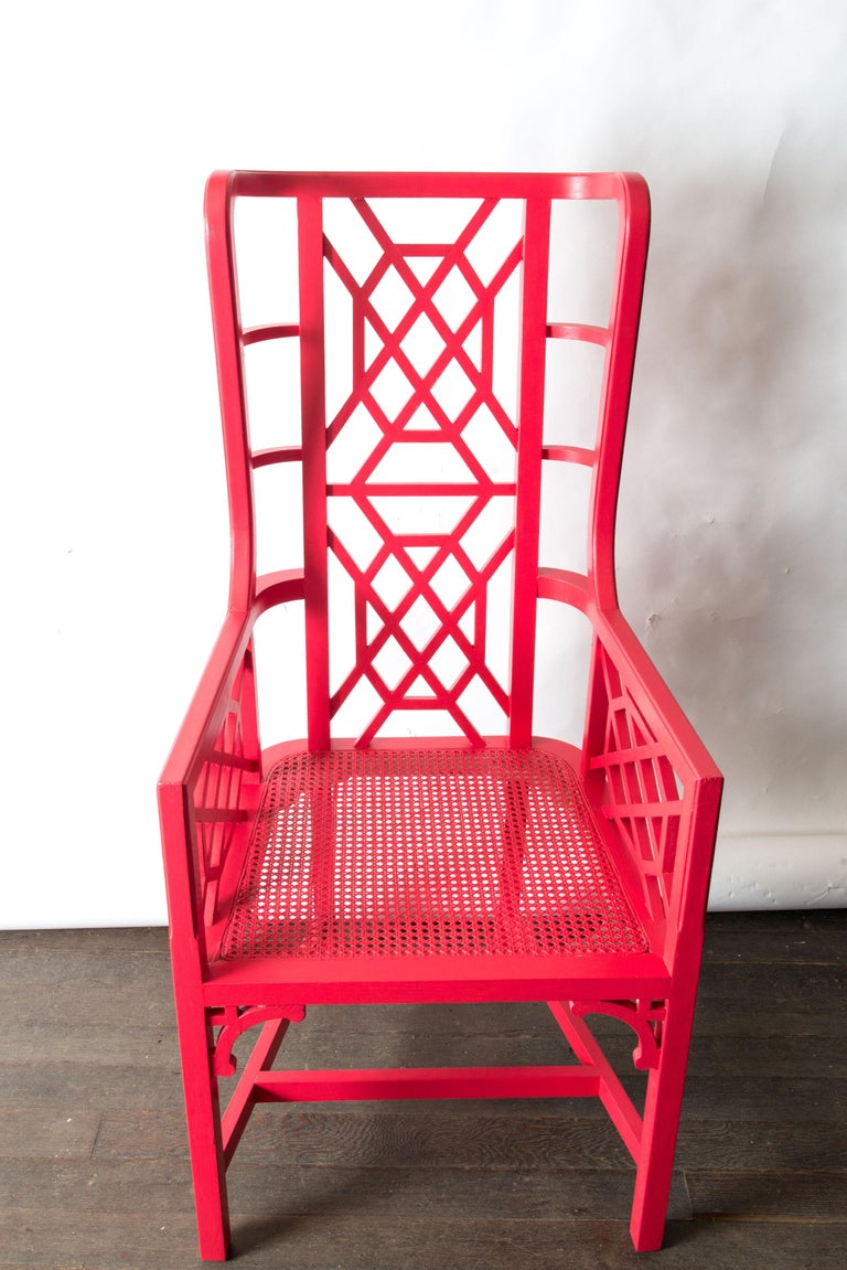 A statement piece wood fretwork Chinese Chippendale chair painted in Chinese red with caned seat. In very good condition.