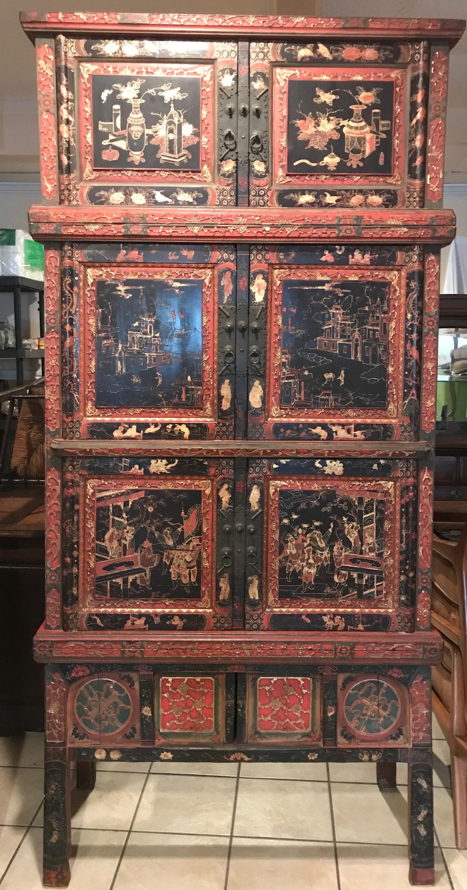 A tall Chinese painted and partial-gilt wedding chest, serves as an armoire, cabinet, bar or storage container. Very intricate hard painting of Asian Chinese motifs architectural designs and figures.

Early 20th century
Measures: 86-1/2 H x