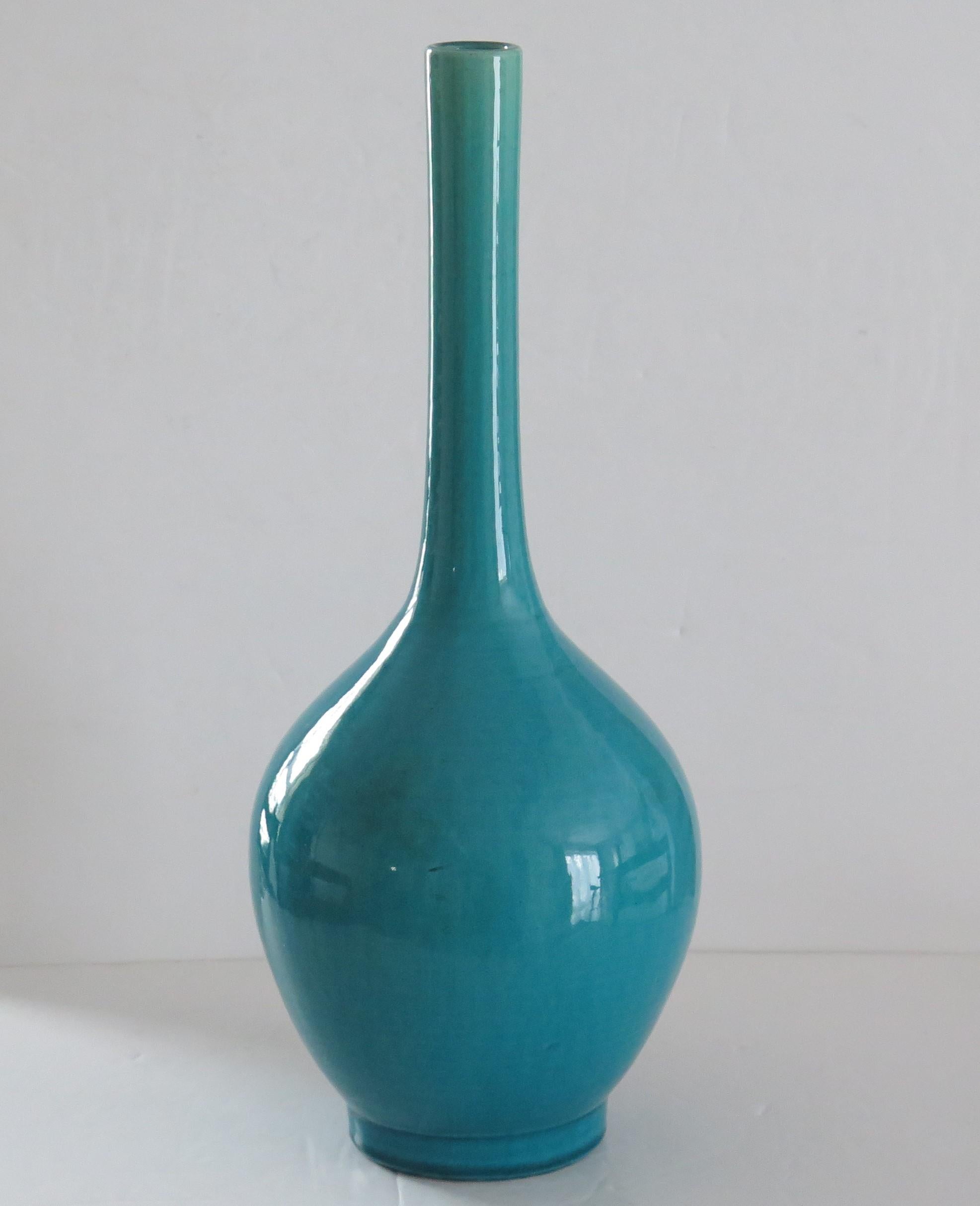 This is a beautiful, very decorative Chinese bottle vase with a monochrome or single glaze colour of turquoise-blue, with very fine crackle glaze, which we date to the early 19th century Qing period or possibly earlier.

The vase is well potted