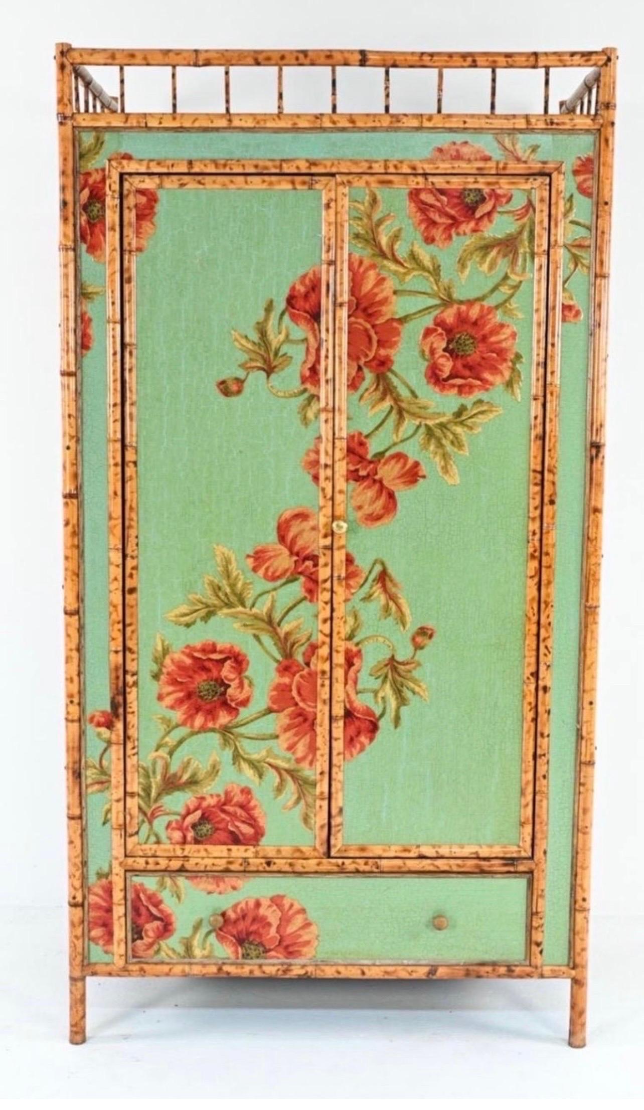 Rare and magnificent chinoiserie cabinet in the aesthetic style decorated with decoupaged floral fabric over teal crackle paint and trimmed in tortoiseshell bamboo. Why not own the best.