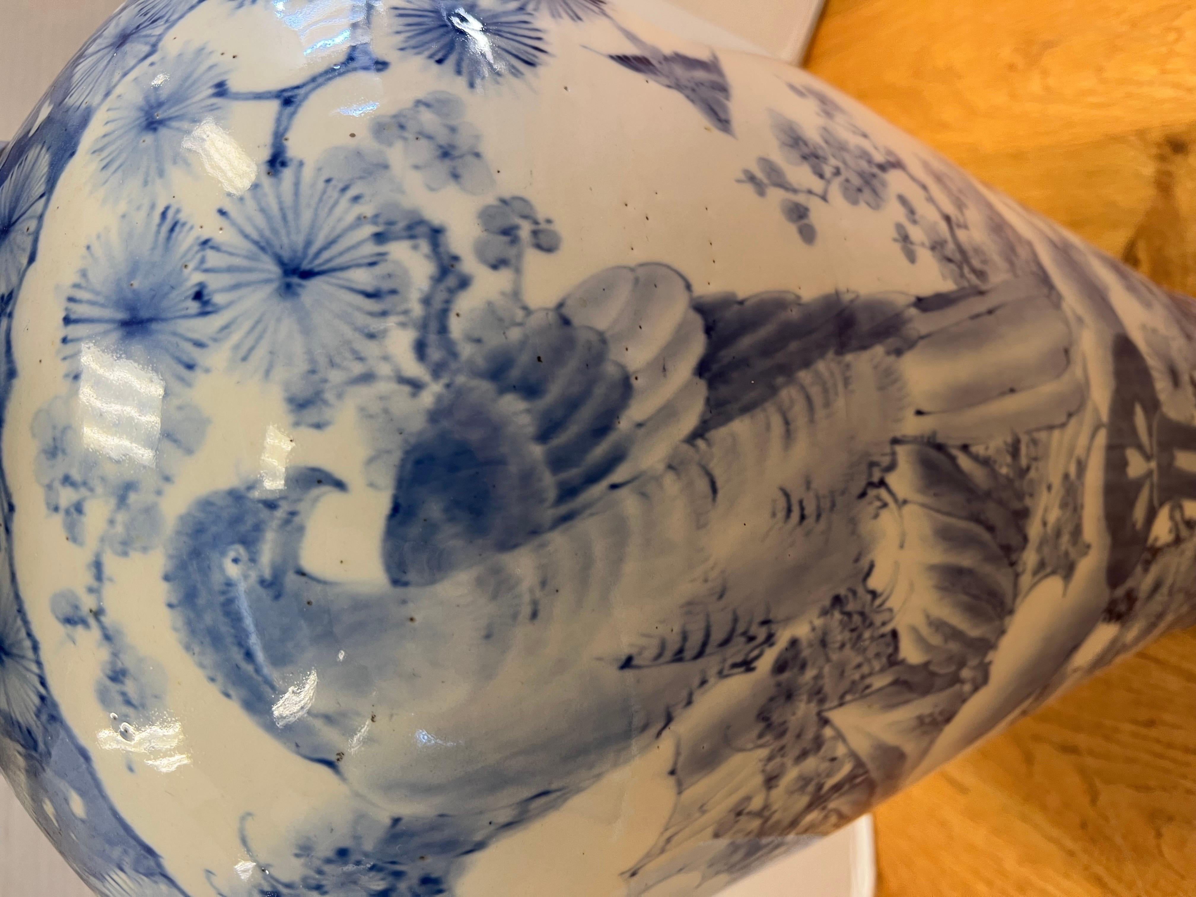 Extra large 32”h Chinese blue and white porcelain covered ginger jar is topped with a blue foo dog. No hallmarks.