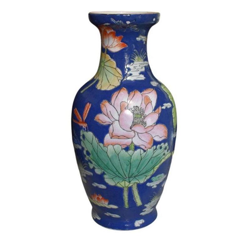 A tall ceramic chinoiserie vase in cobalt blue. We don't often come across deep blue chinoiserie vases, so when we do, we snap them up! This piece is tall and features hand-painted birds, flowers, and foliage throughout. The flowers vary in hues of