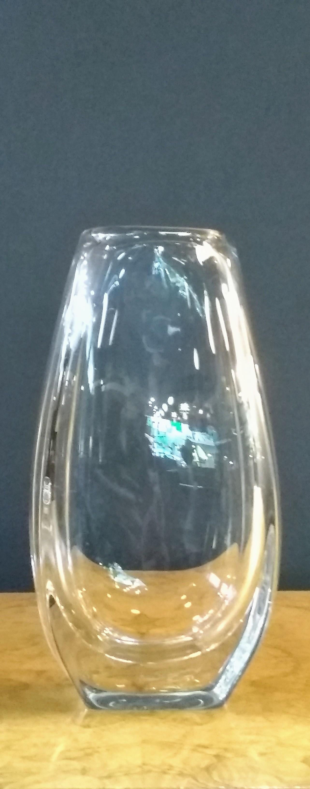 Amazing clear decorative leaded crystal vase in the manner of Orrefors. Upright, oval and fluted, at nearly eleven inches the vase is perfect for tall bouquets or simple display. Stabile and very well balanced.