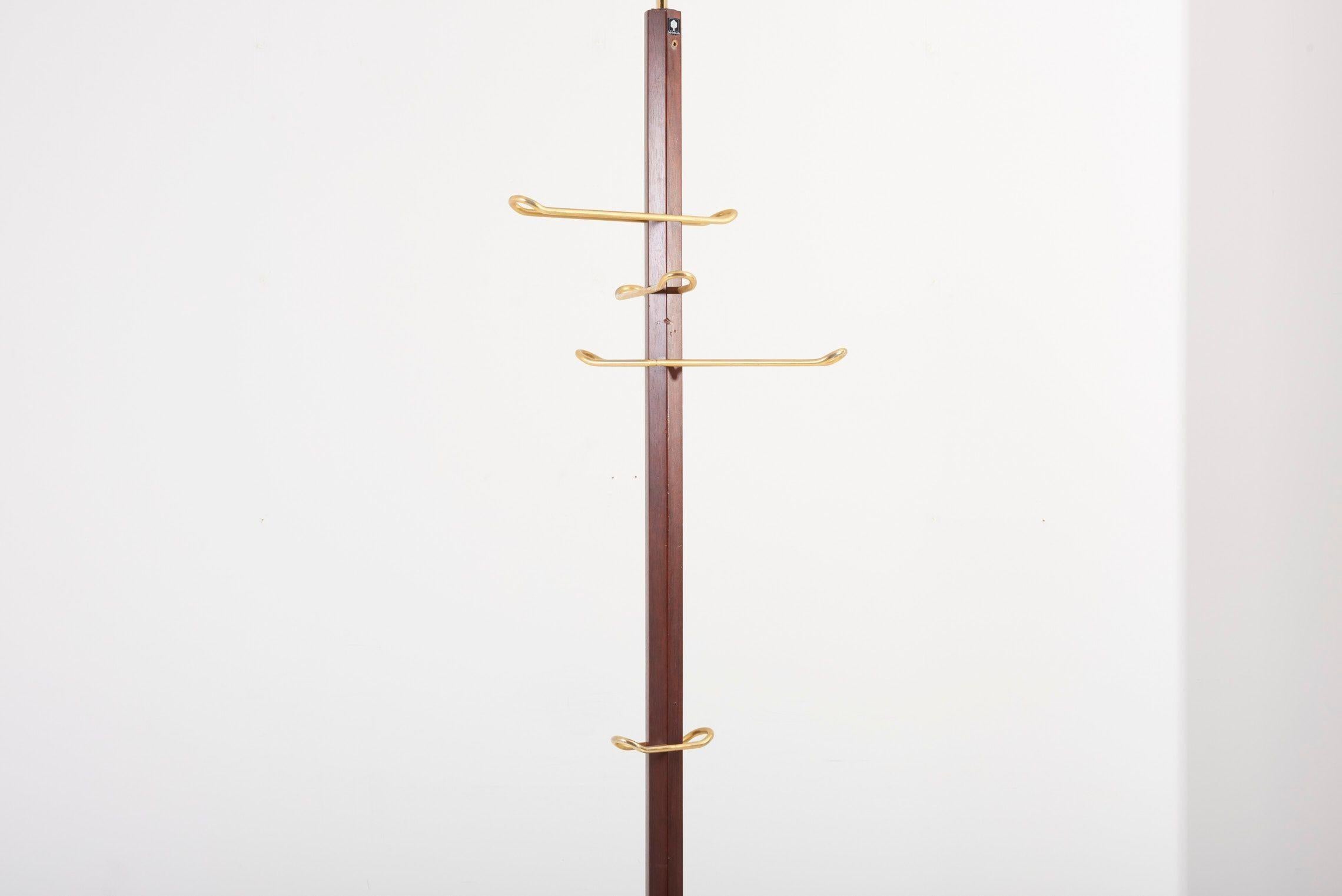 Coat Rack by Schönbuch with teak base and brass elements. Labeled. The max, height is 320cm. The teak has some nicks and dents.