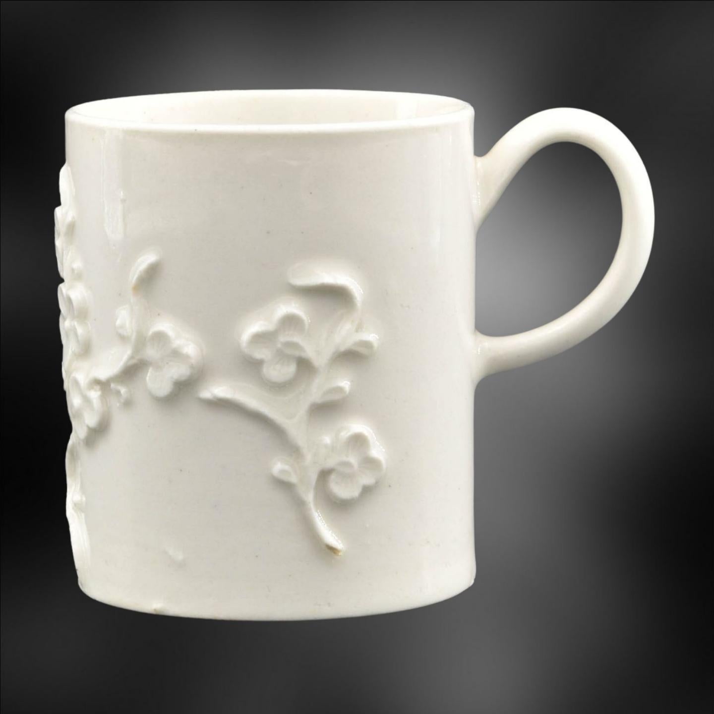 A Blanc de Chine Coffee can with straight sides and simple loop handle, and with one finely detailed prunus spray and two smaller sprays.

An unusually tall example.

Provenance: Stockspring Antiques, London

Literature: Featured in White