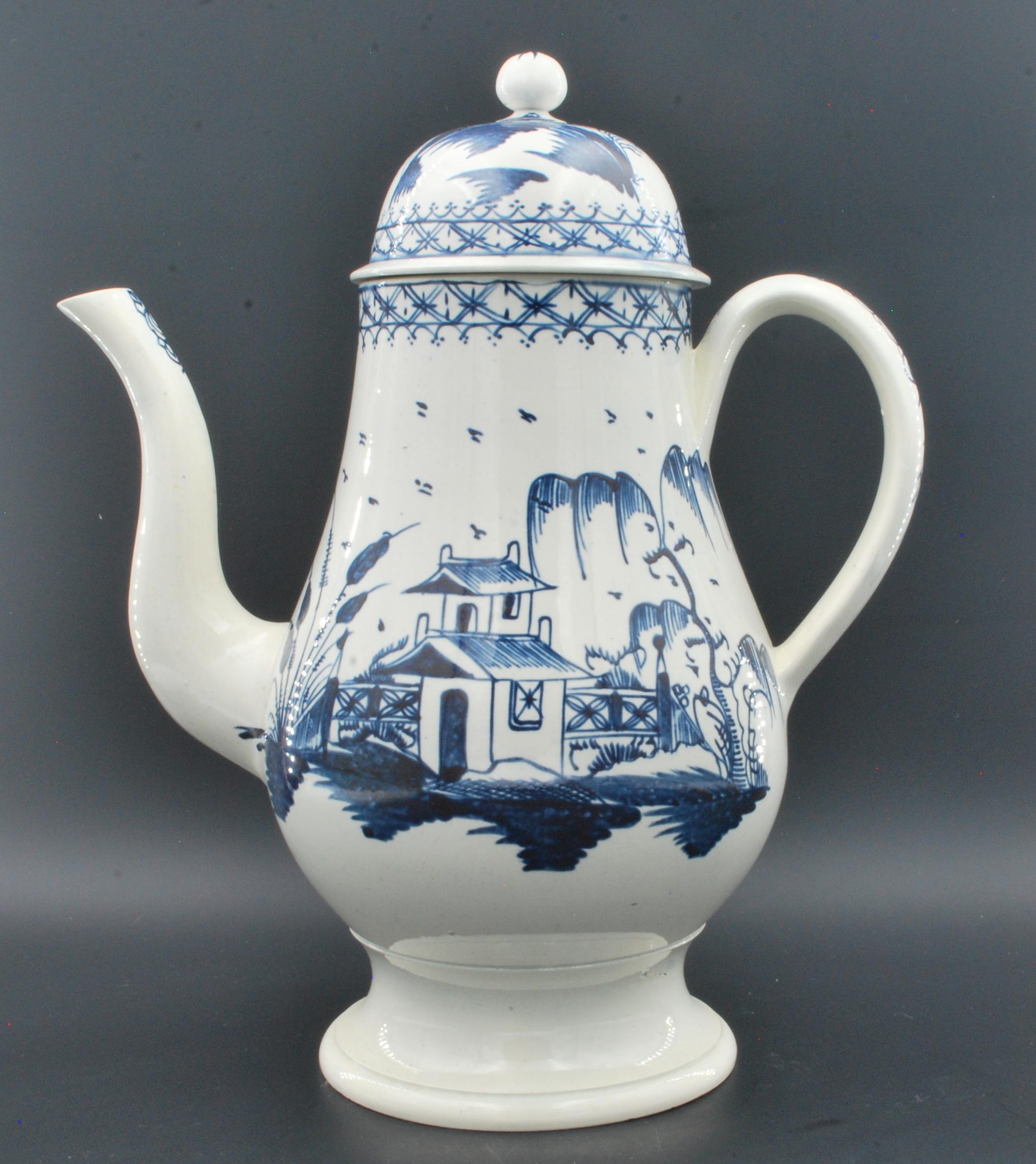A fine and large - enormous - coffee or chocolate pot in pearlware, with  “House & Fence” decoration, in imitation of a Chinese original.

It is thought that these oversixed pots were intended as decoration, or to be put in the window of