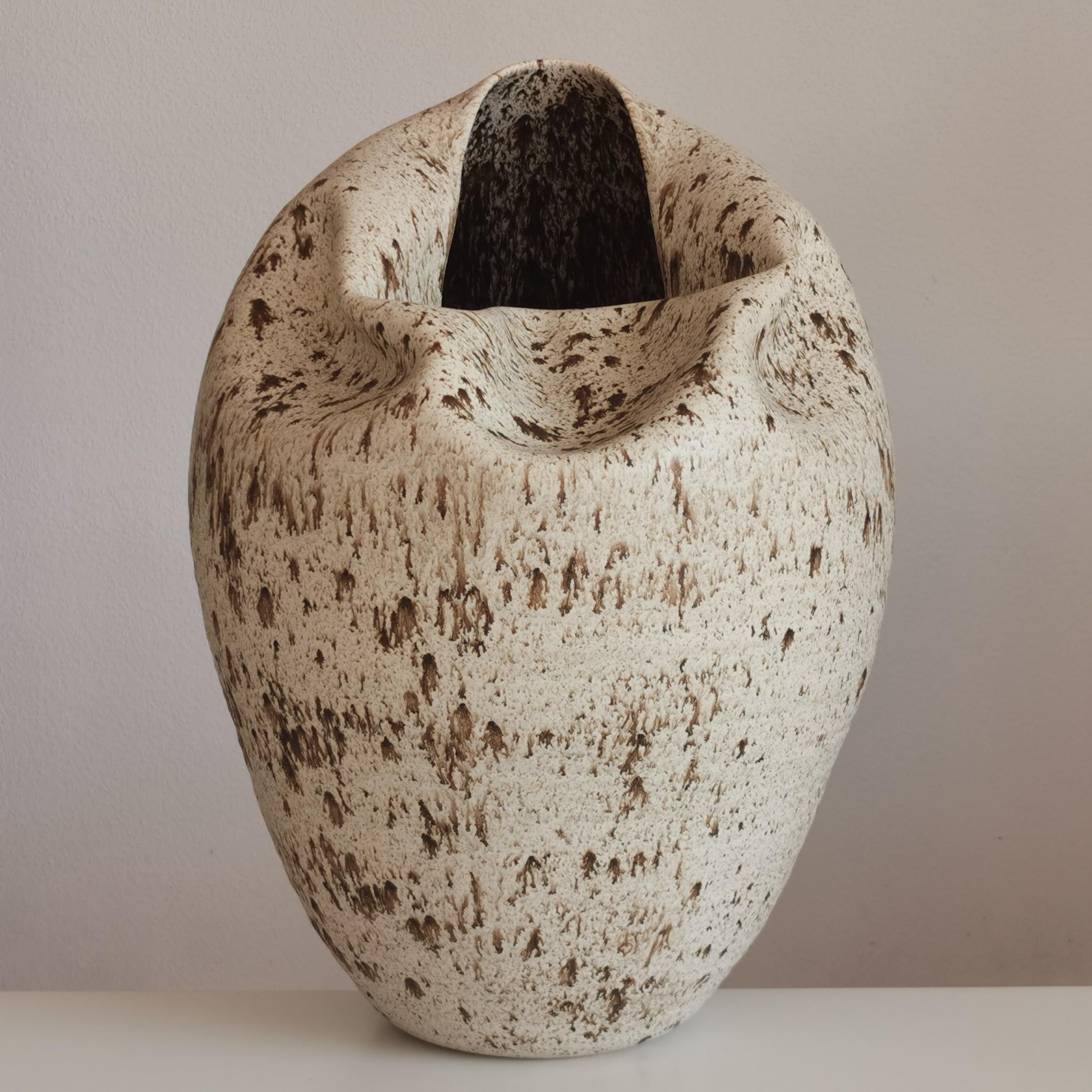N. 93 tall collapsed form with white speckled glaze. Large sumptuous vessel from ceramic artist Nicholas Arroyave-Portela.

Materials: White St. Thomas clay, Stoneware glazes, multi fired to cone 6 (1223 degrees)

H 48 cm W 32 cm D 37 cm

Made