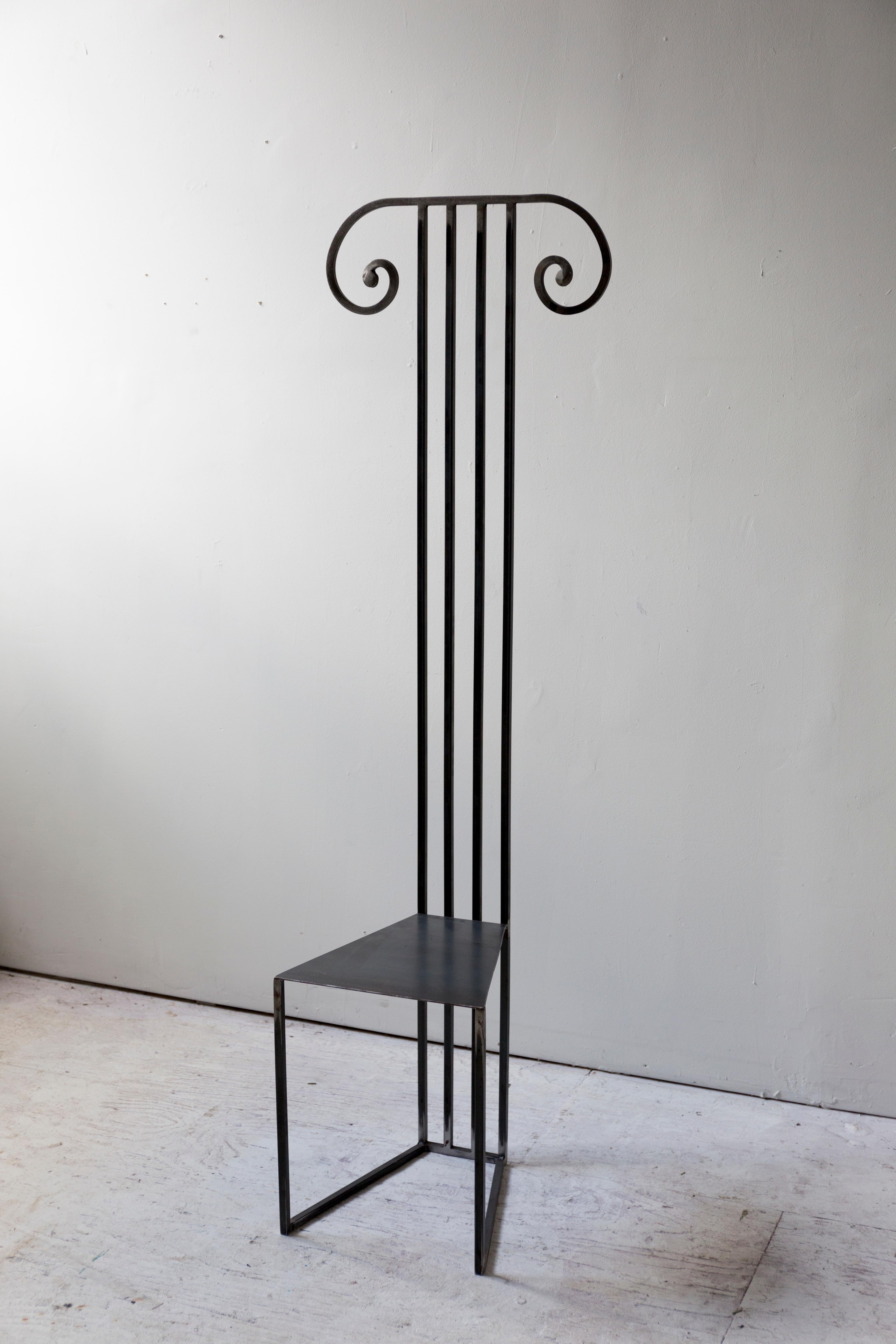 The Column Chair brings a striking architectural silhouette to any space. Solid steel rods transition into scrolls at the top of the chair, evoking classic ionic columns. The flared seat is comfortable while maintaining a pleasing sense of scale.