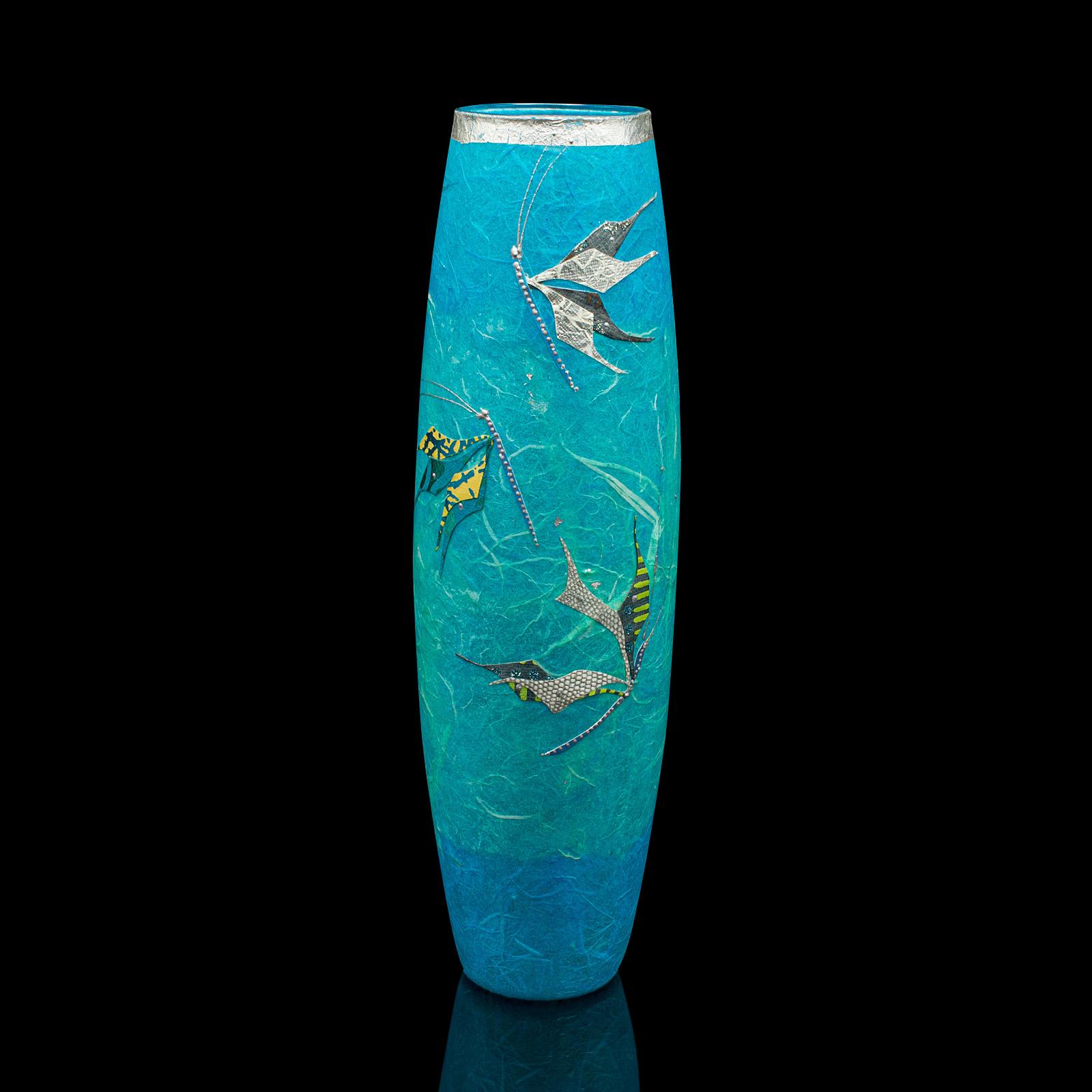
This is a contemporary decorative flower sleeve. An English, art glass and straw silk vase by Margaret Johnson.

Beautiful colour with butterfly motif attracts the eye
Displays a desirable, contemporary appearance
Colourful glass beams in the