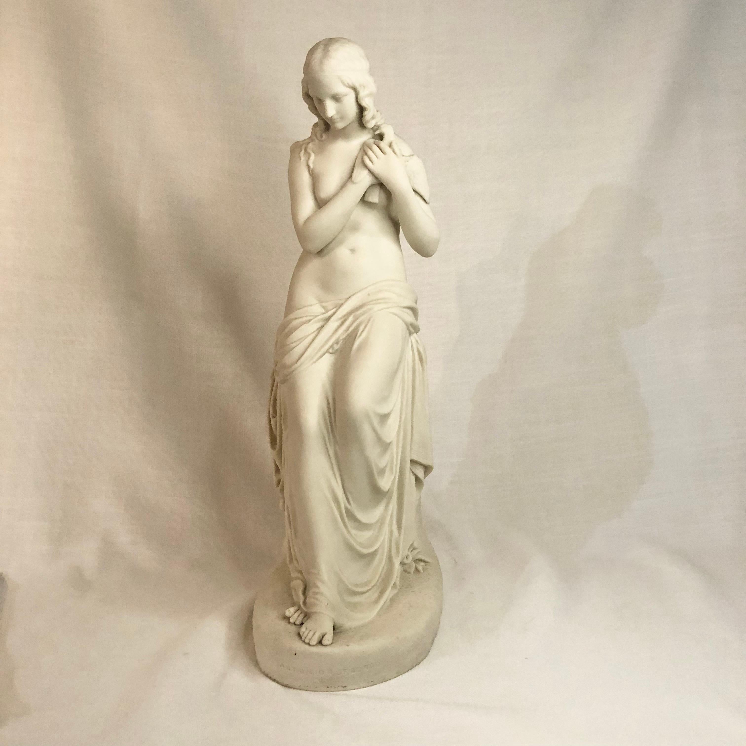 I want to offer you this gorgeous parian figure named Innocence. She is a beautiful semi-nude figure with draping fabric on the lower part of her body. She is holding a dove against her chest. The dove represents virtue. The modeler made Innocence