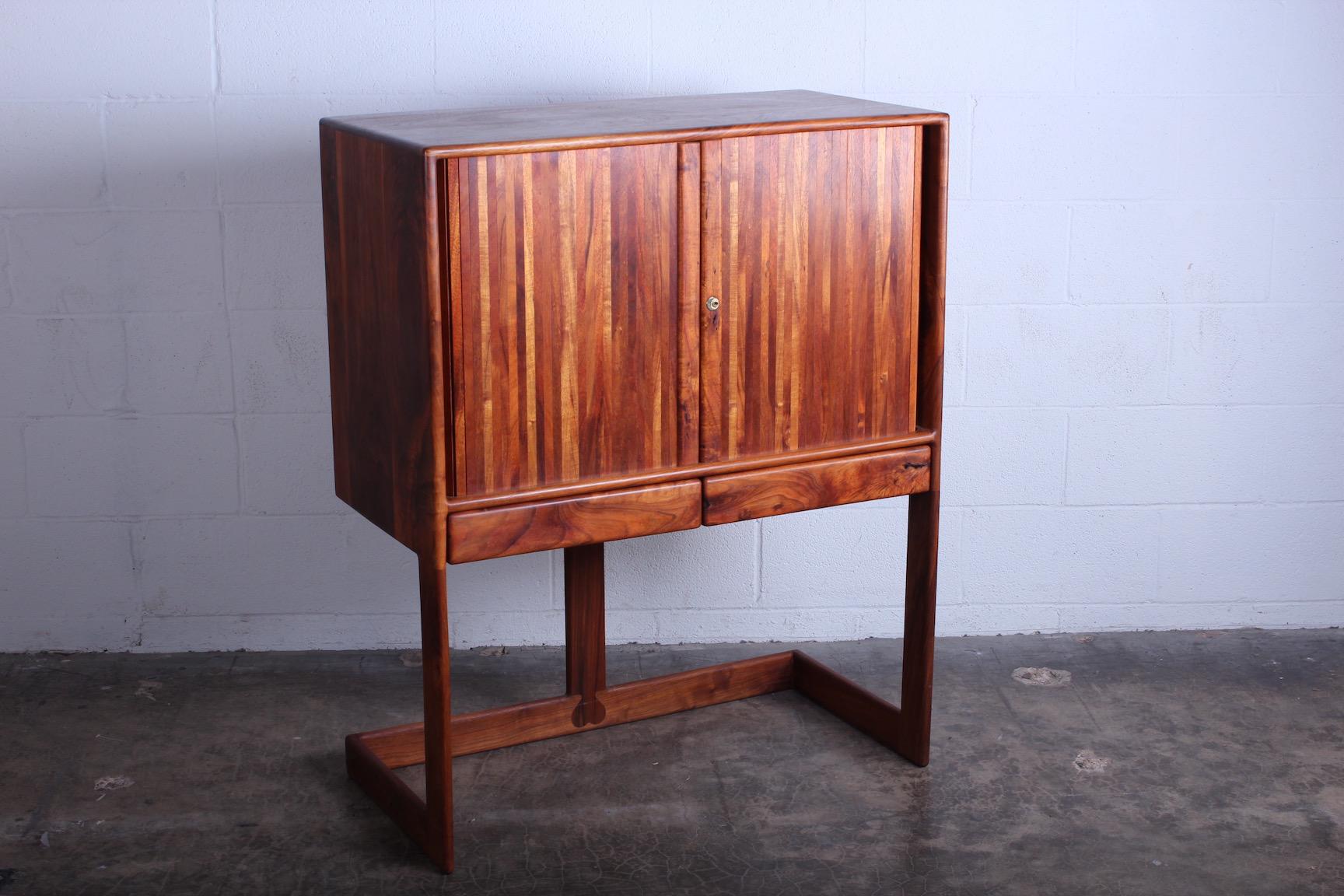 A beautifully crafted walnut tambour door cabinet with interior drawers. Made by Robert and Joanne Herzog, 1970s, California.