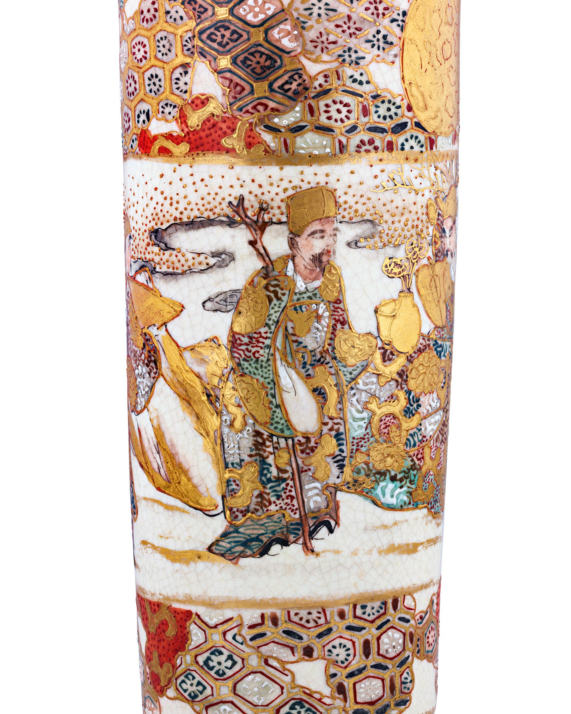 This vibrant and ornate vase captivates the eye with its intricate details which stand as a testament to the mastery of Satsuma artists. The vase features rich reds, deep blues and shining gold, all interwoven in geometric patterns alongside floral