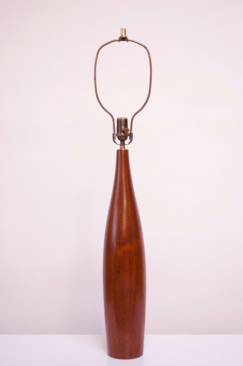 1960s sculptural turned teak Danish lamp by ESA. Features a counterweighted base to better support the tall form. Retains the brass insert on the underside bearing the 'ESA, Made in Denmark' manufacturer's mark. Newly rewired; the silk cord is shown